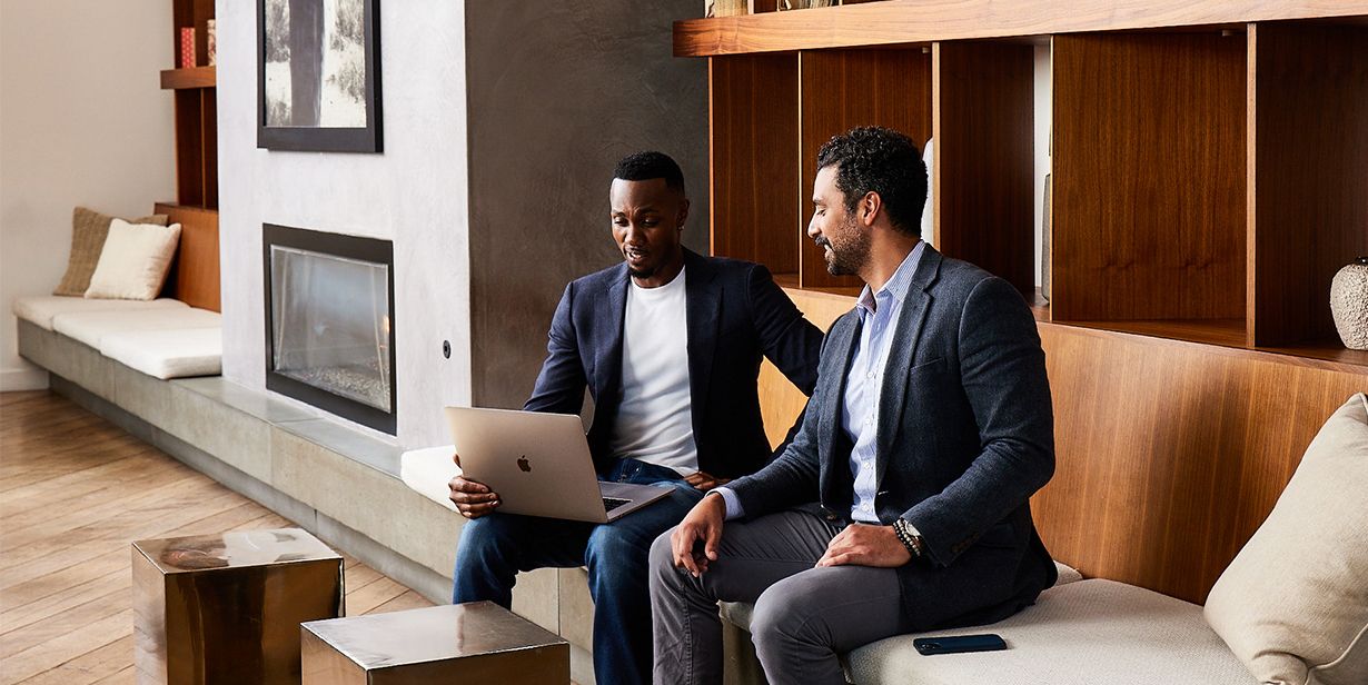 business travellers in lobby of hotel with laptop