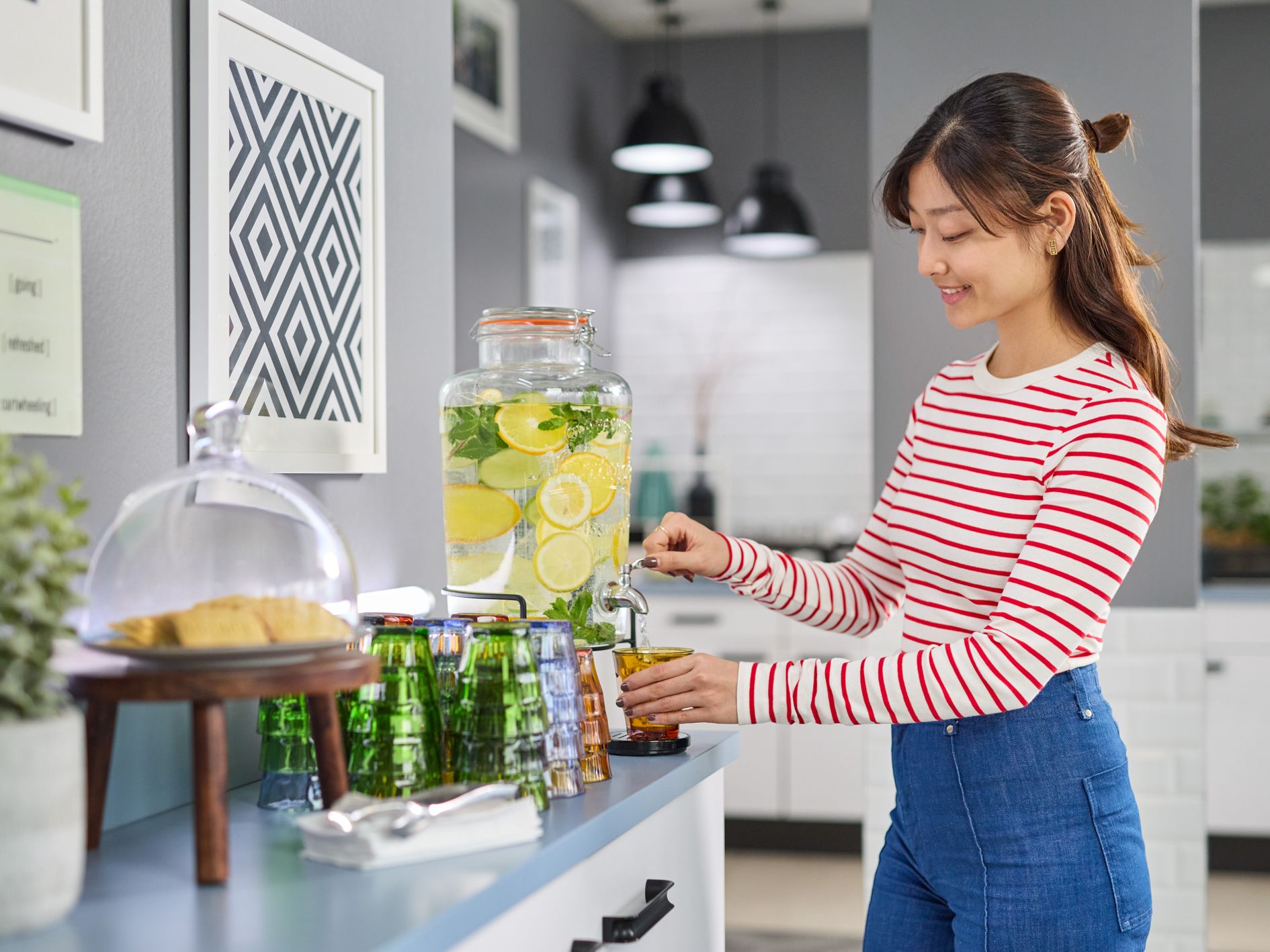 Woman filling her glass at the flavoured water station