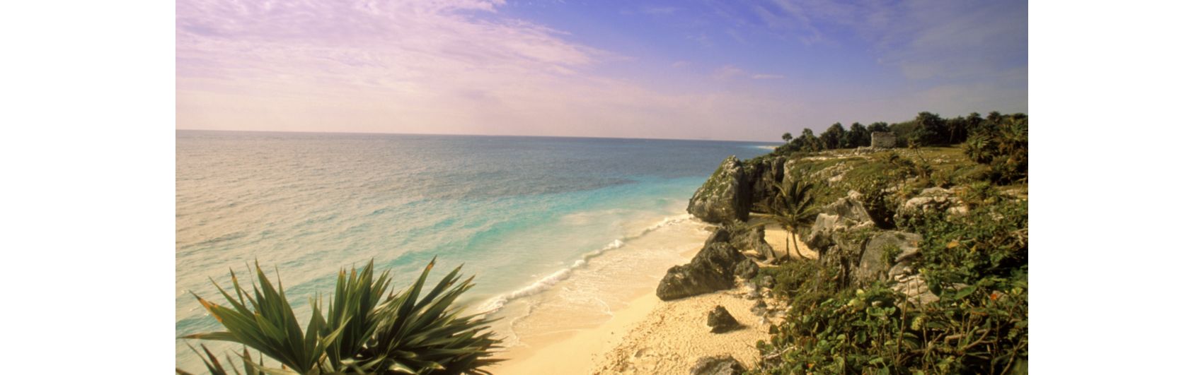 Beach and rocky craggy cliff overlooking the ocean on yucatan peninsula