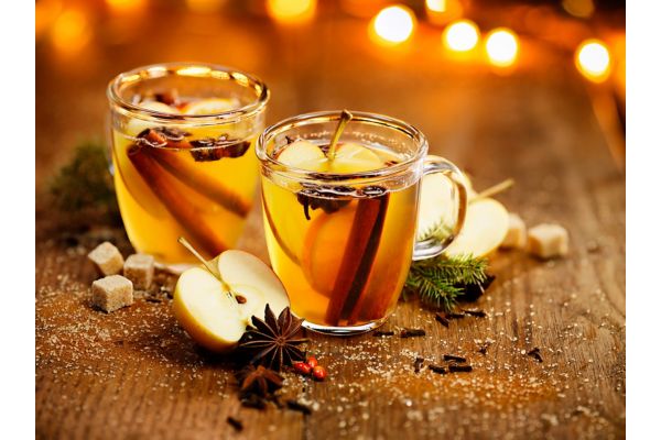 Hot cider with addition of cinnamon sticks, anise stars, cloves and citrus fruits