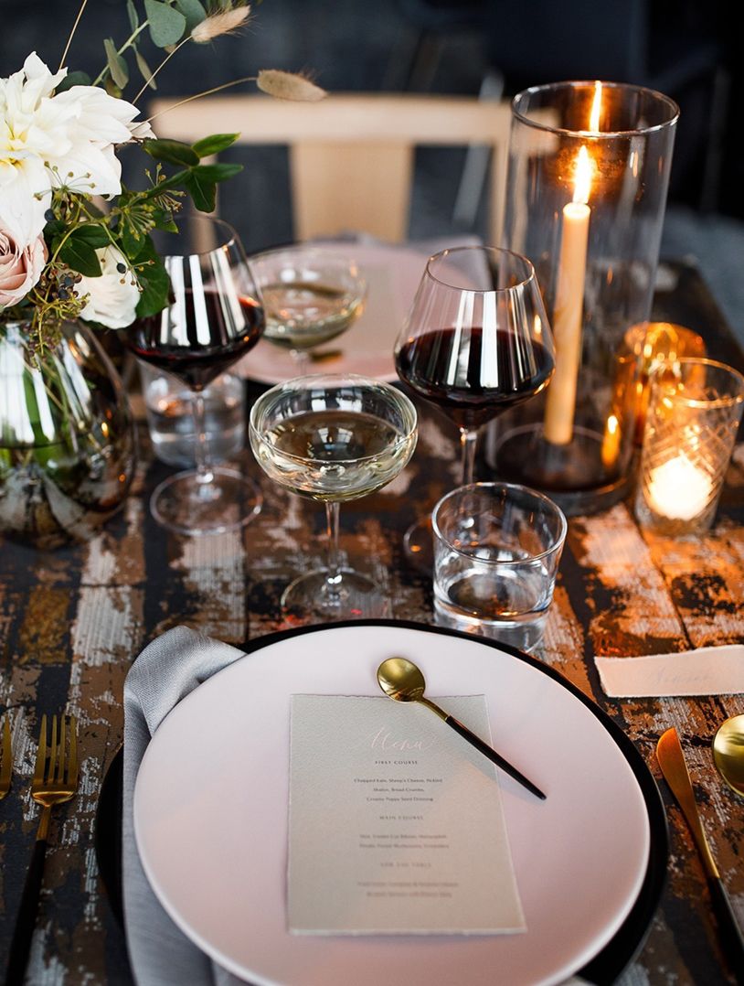man in a suit holding a cute gray puppy with a pearl leash
