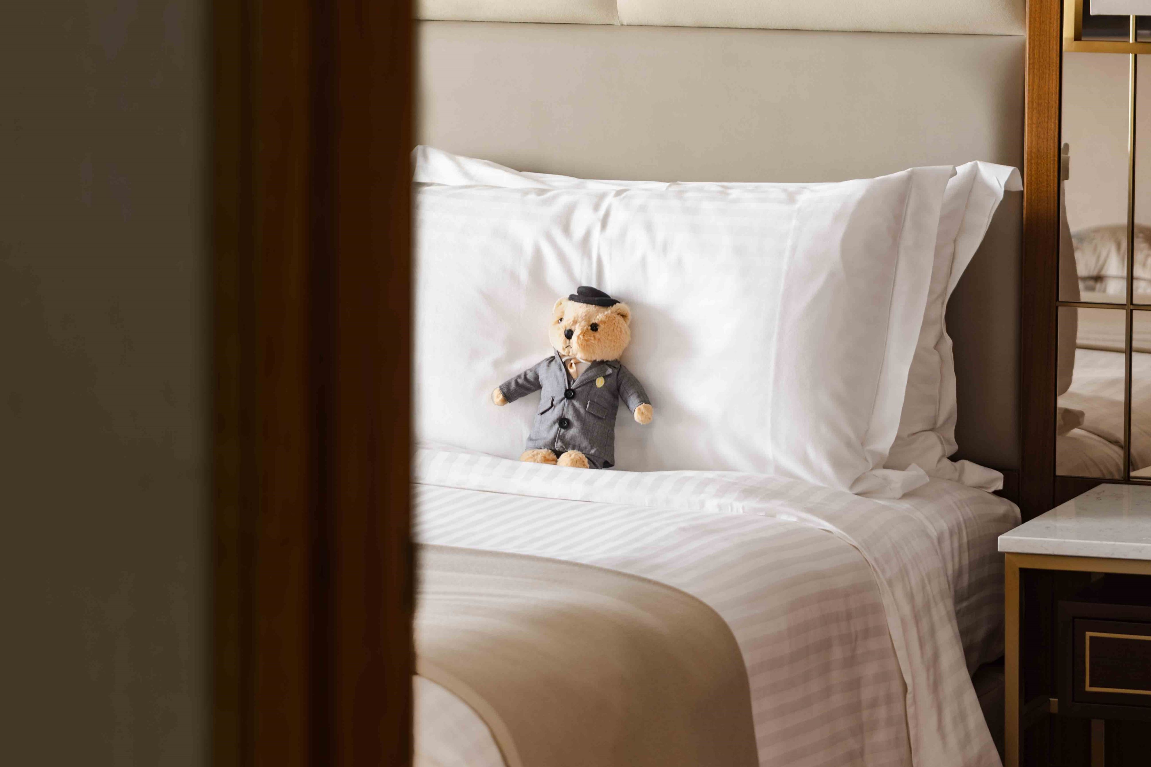 Teddy bear on a hotel bed