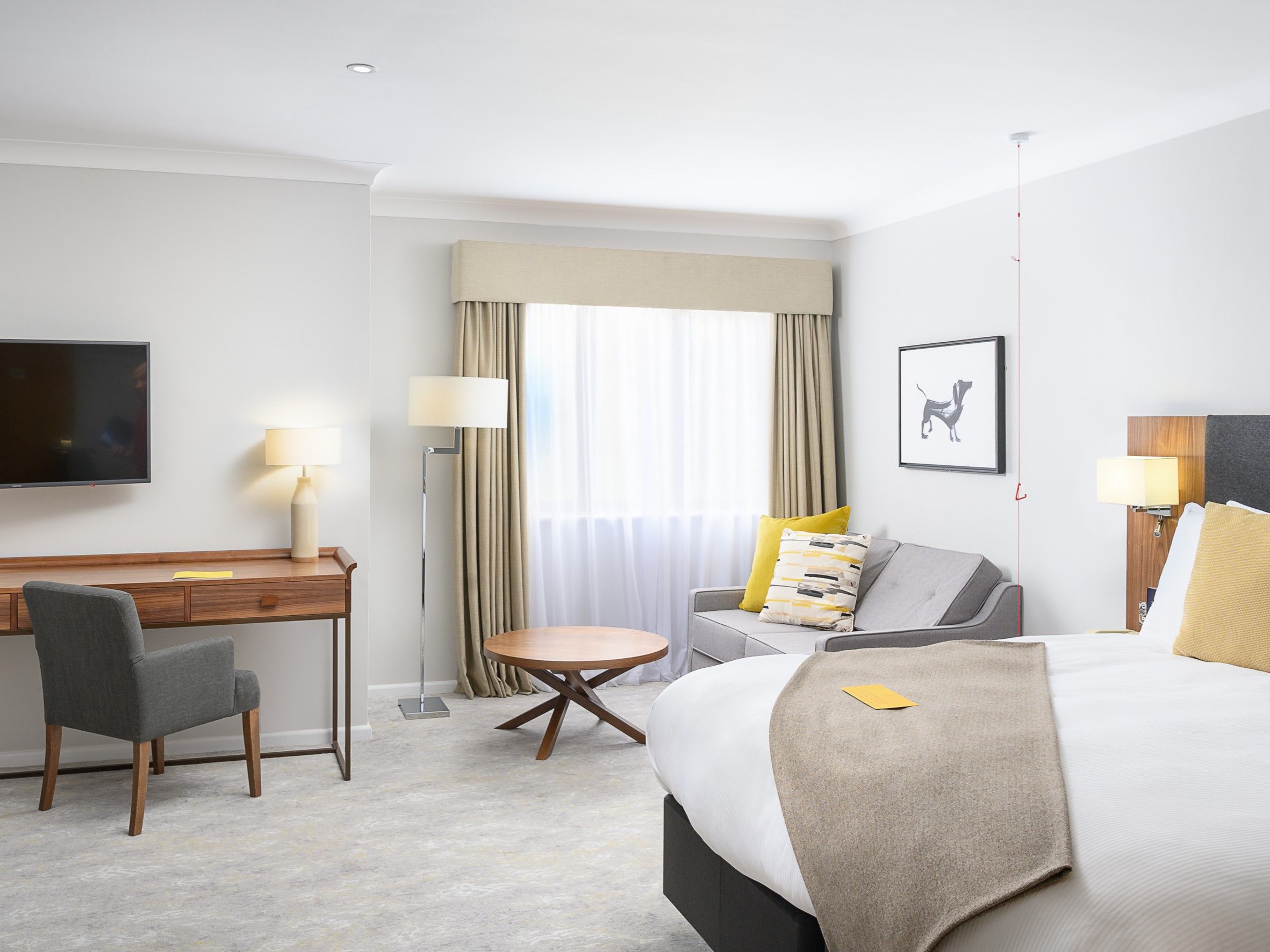 hotel room with bed, seating and desk