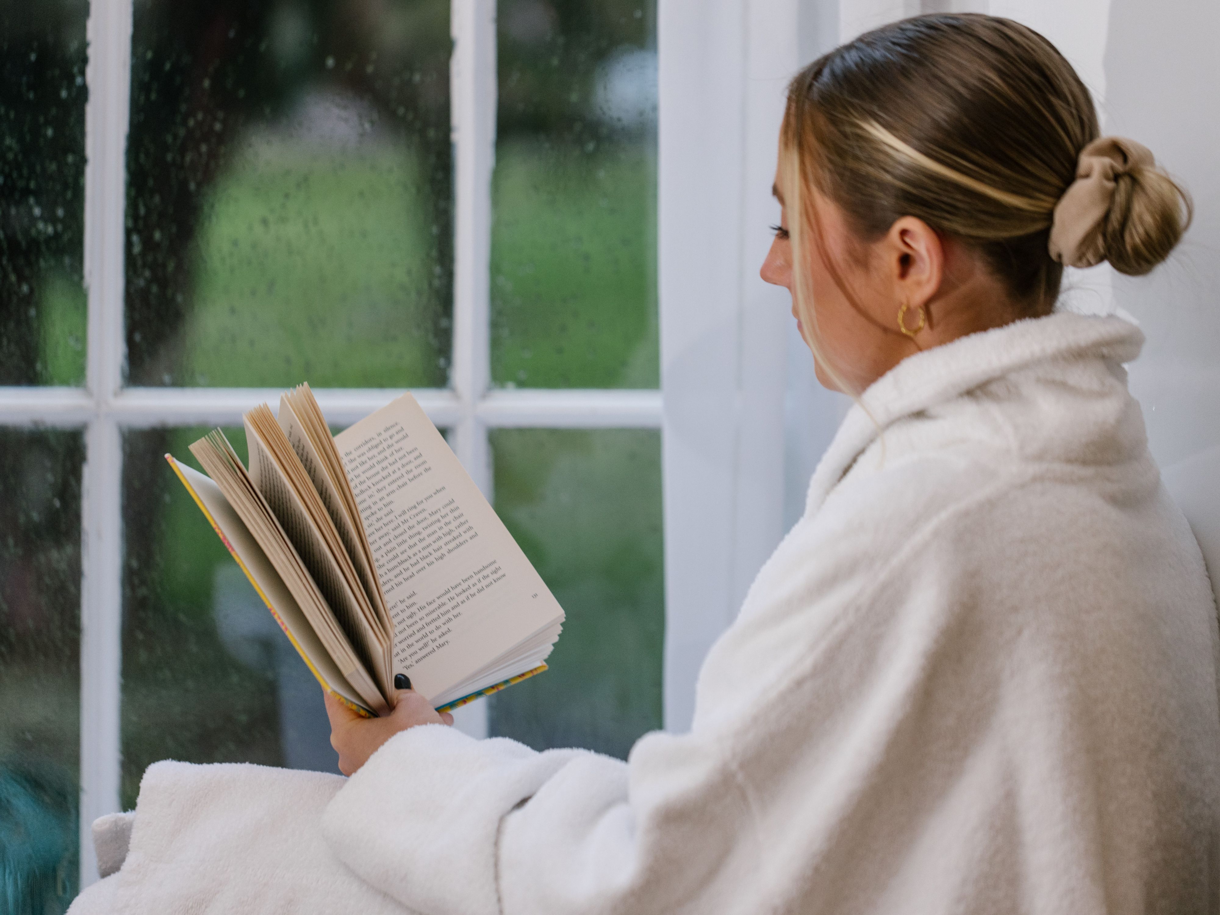 Woman reading a book in hotel room