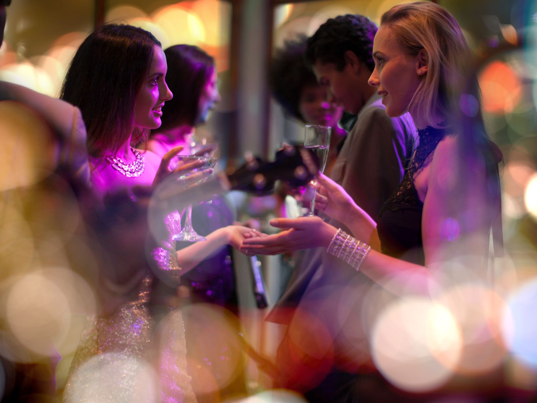 Two women talking at a party.
