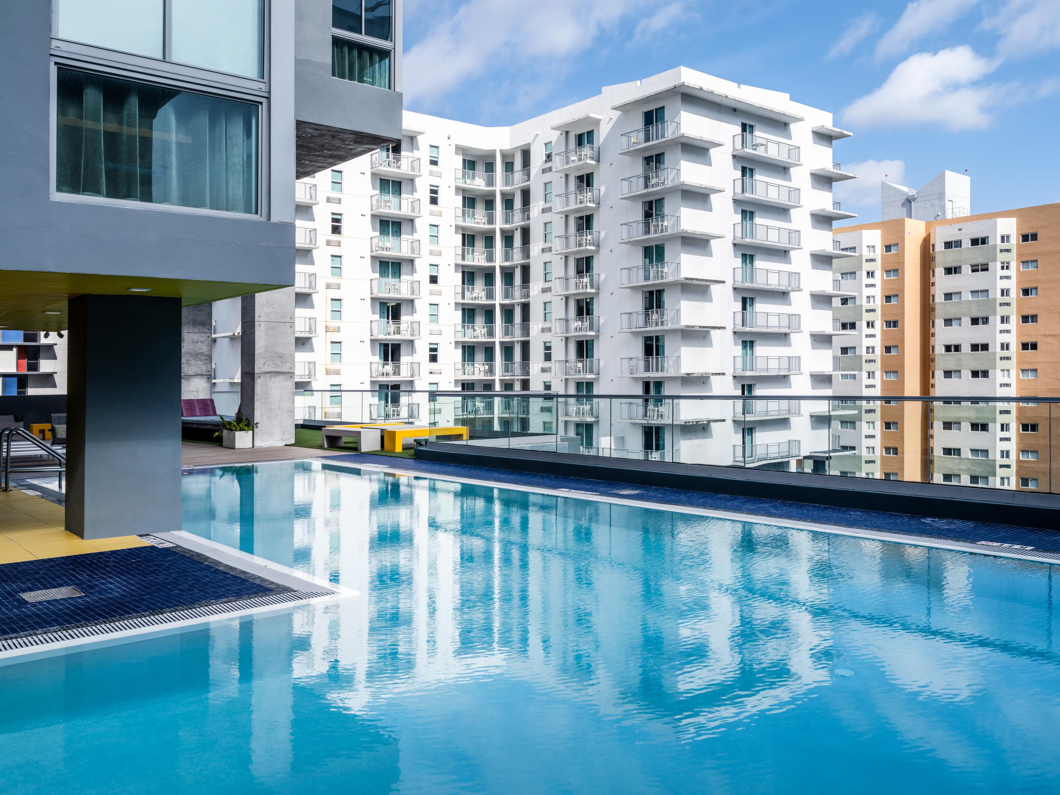 Enjoy our premium amenities without the fees. Take a refreshing dip or lounge poolside at our sparkling rooftop pool and enjoy panoramic views, daily from 8:00AM to 8:00PM. Get energized at our 24/7 fitness studio with state-of-the-art equipment. Also enjoy our 24/7 guest laundry facility, a 24/7 Market in the Lobby, and free high-speed Wi-Fi.