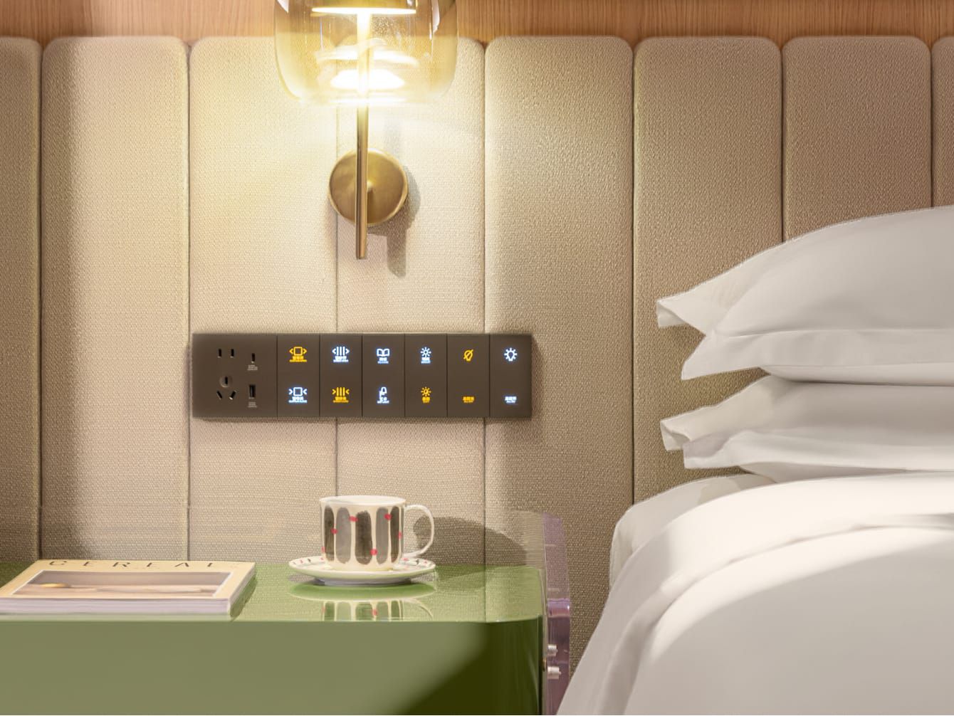 A smart control panel next to a freshly made hotel bed