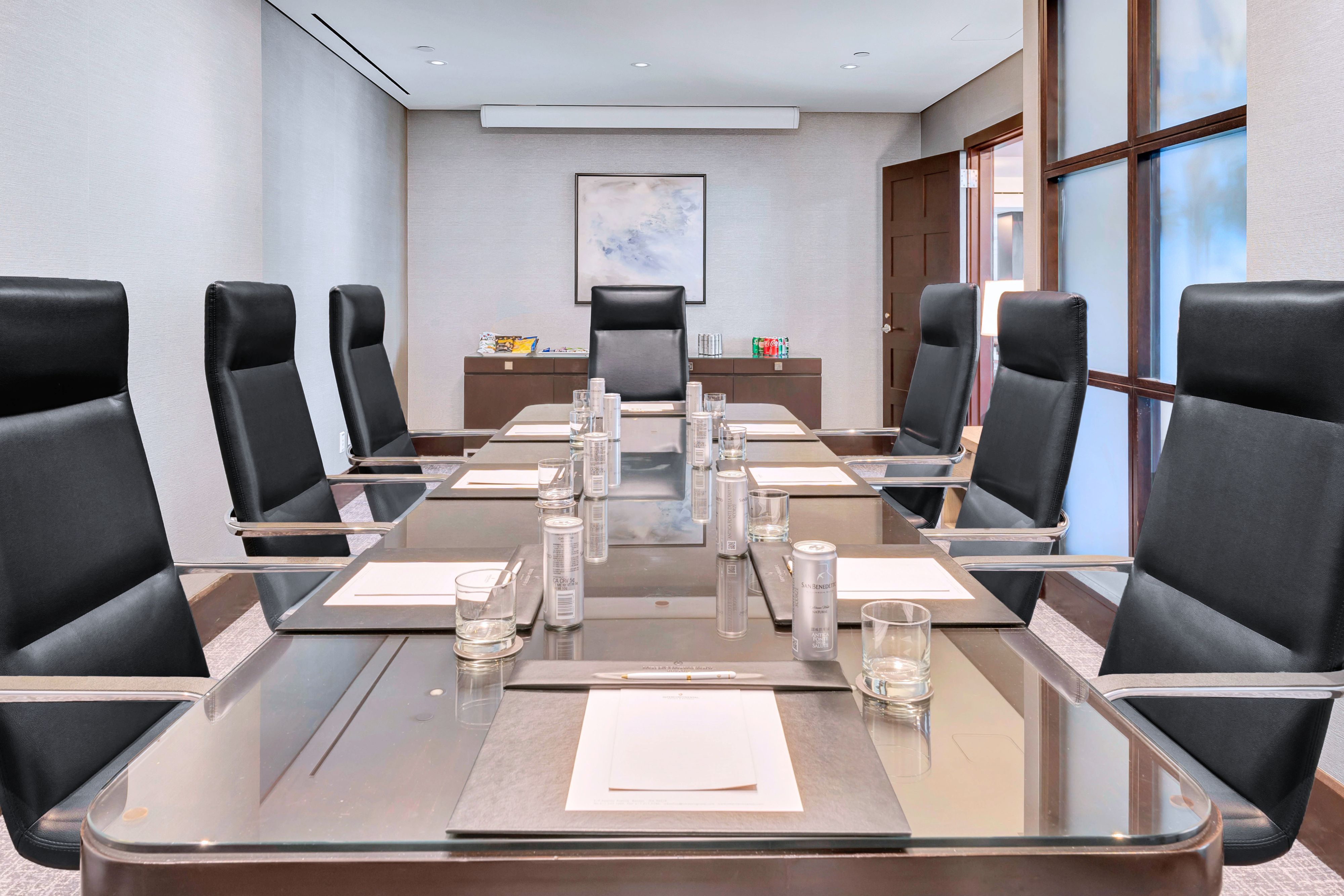 Conference table set up with meeting supplies.