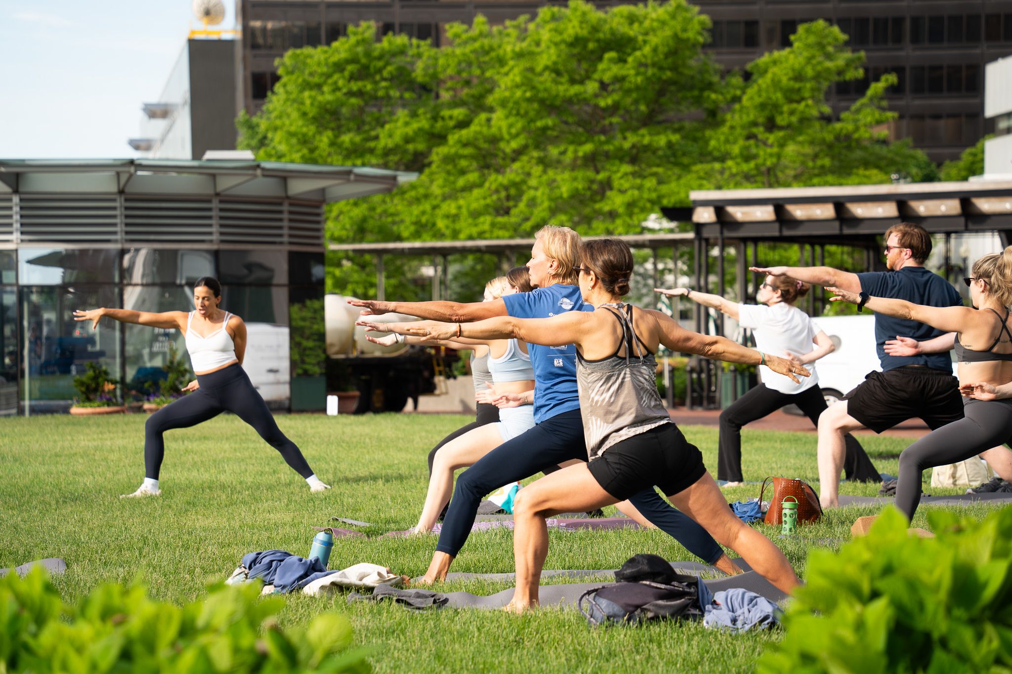 Guests doing warrior 2 pose while instructor demonstrates.