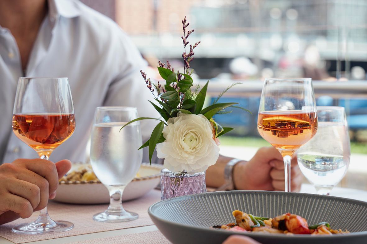 Close up of wine and entrees at IC Boston restaurant.