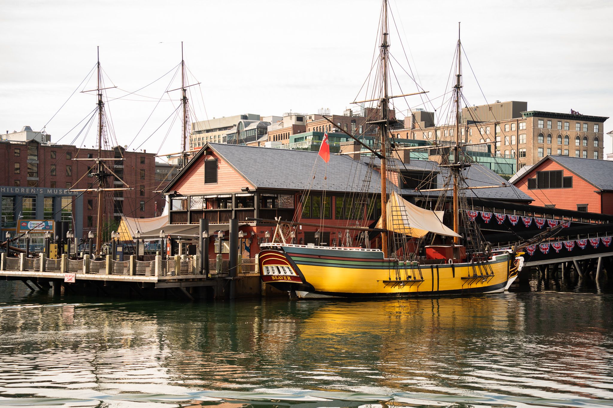 Yellow boat sitting by the dock at Boston Harbor.