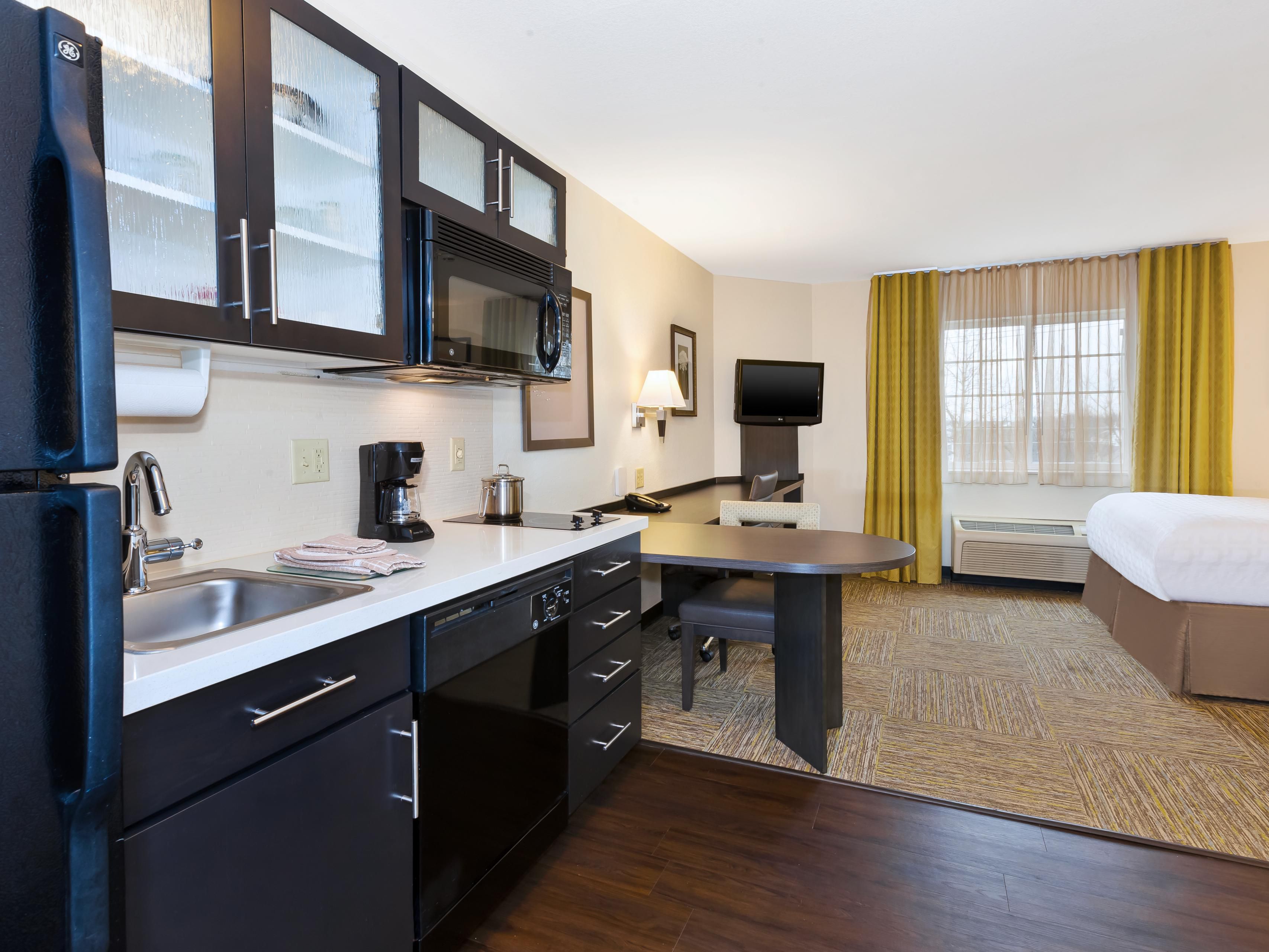 Suite with fullsize kitchen, refrigerator, stove top and microwave