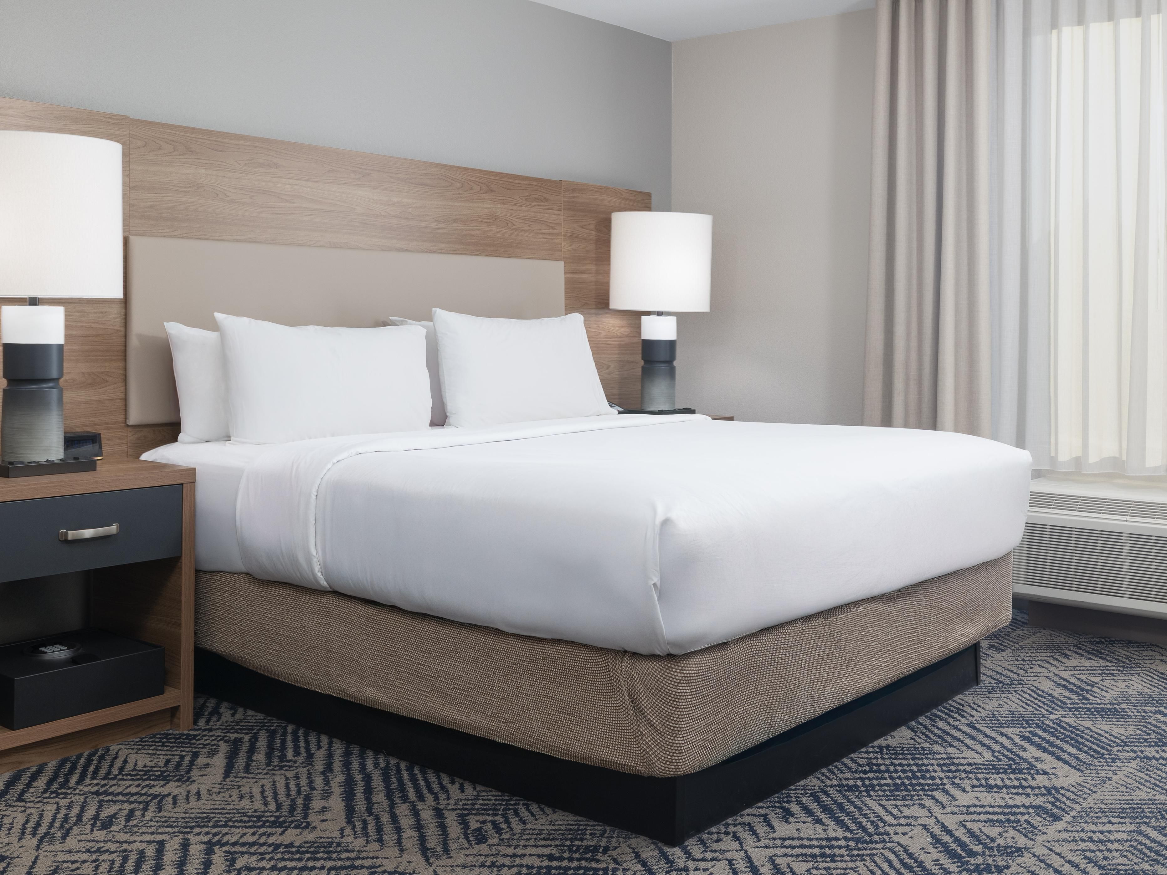 King Studio with plush bedding and modern workspace