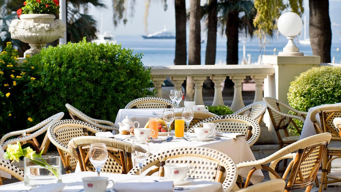 table set with breakfast on outdoor courtyard with water views