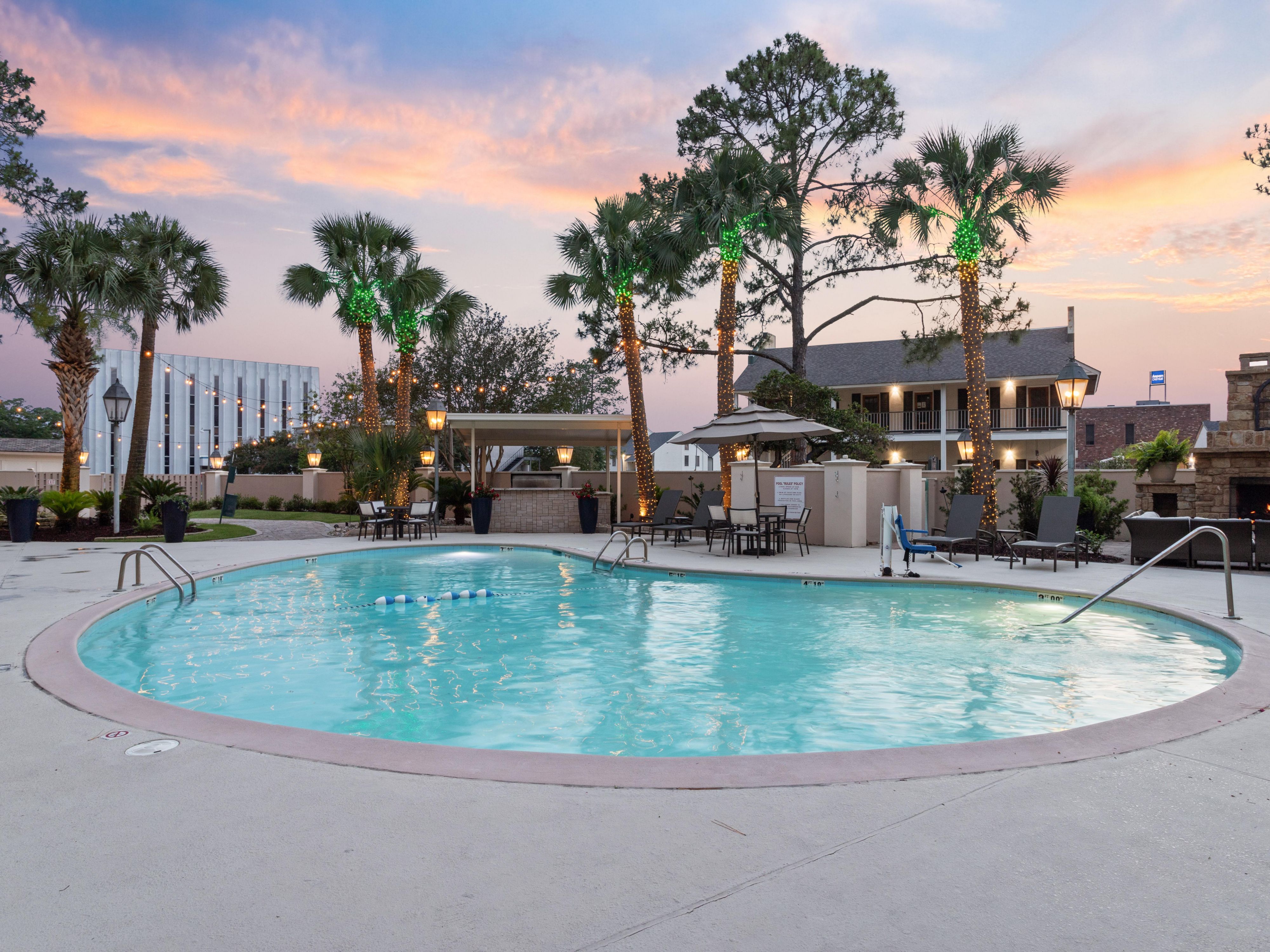 Escape the Louisiana heat with a refreshing dip in our outdoor pool or lounge poolside beneath shaded umbrellas. Our courtyard patio offers a serene oasis for relaxation, surrounded by lush palm trees. Whether you're looking to soak up the sun or enjoy a peaceful retreat outdoors, our pool and patio provide the perfect setting.