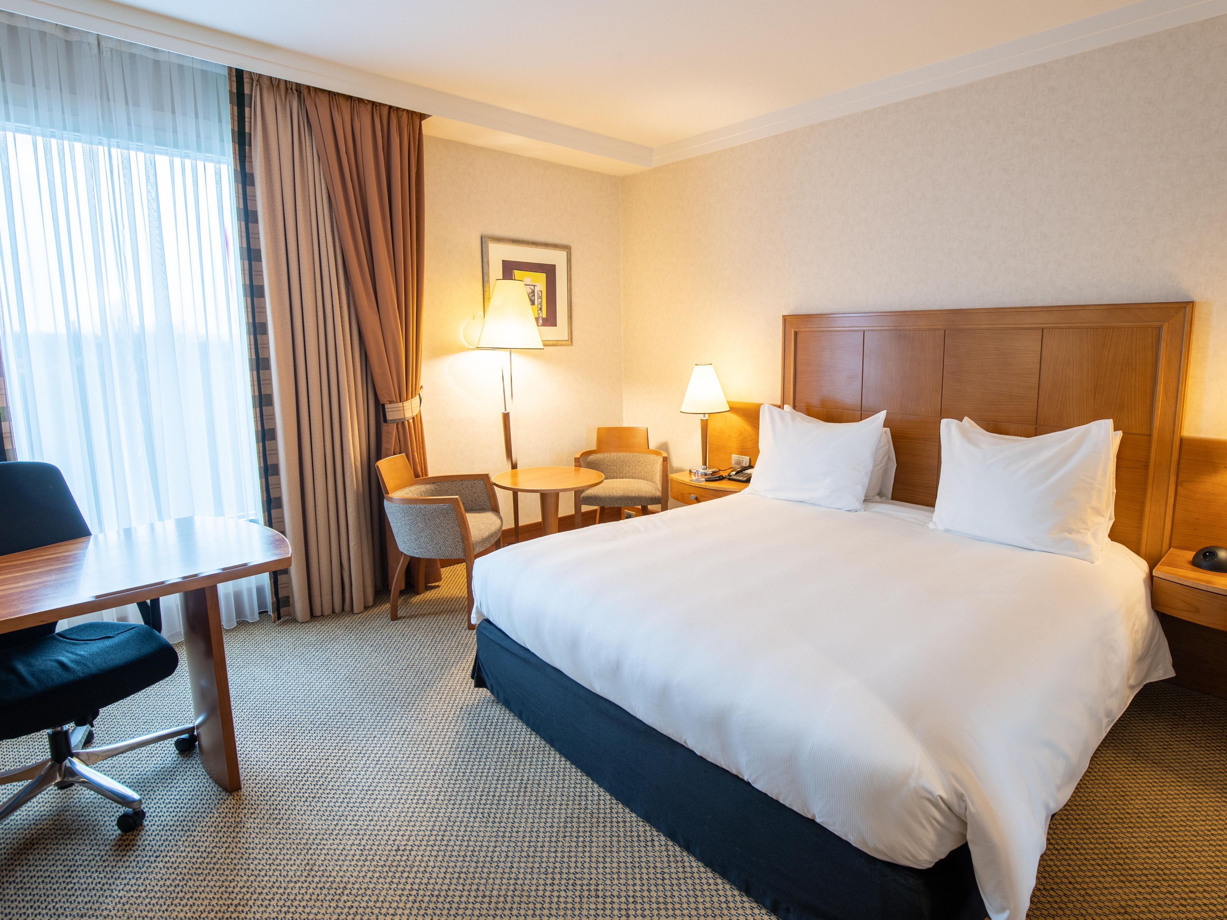 Unwind in our spacious king room with premium bedding.