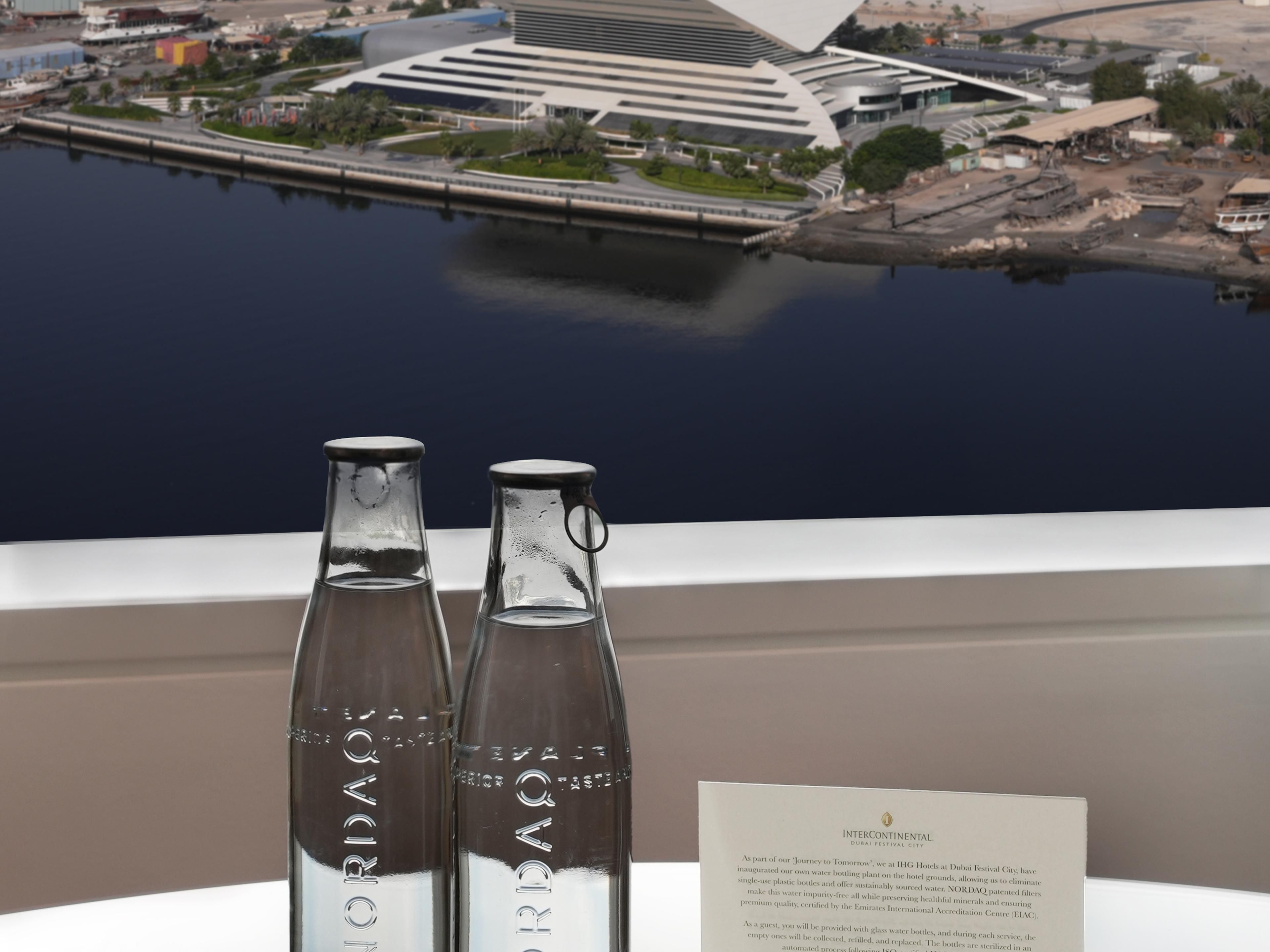 Discover a greener future with every stay at IHG Hotels at Dubai Festival City. Our state-of-the-art NORDAQ glass bottling plant significantly reduces water waste, ensuring a more sustainable environment. We've eliminated single-use plastic bottles in favour of reusable glass bottles, providing an elegant and eco-friendly solution for our guests.