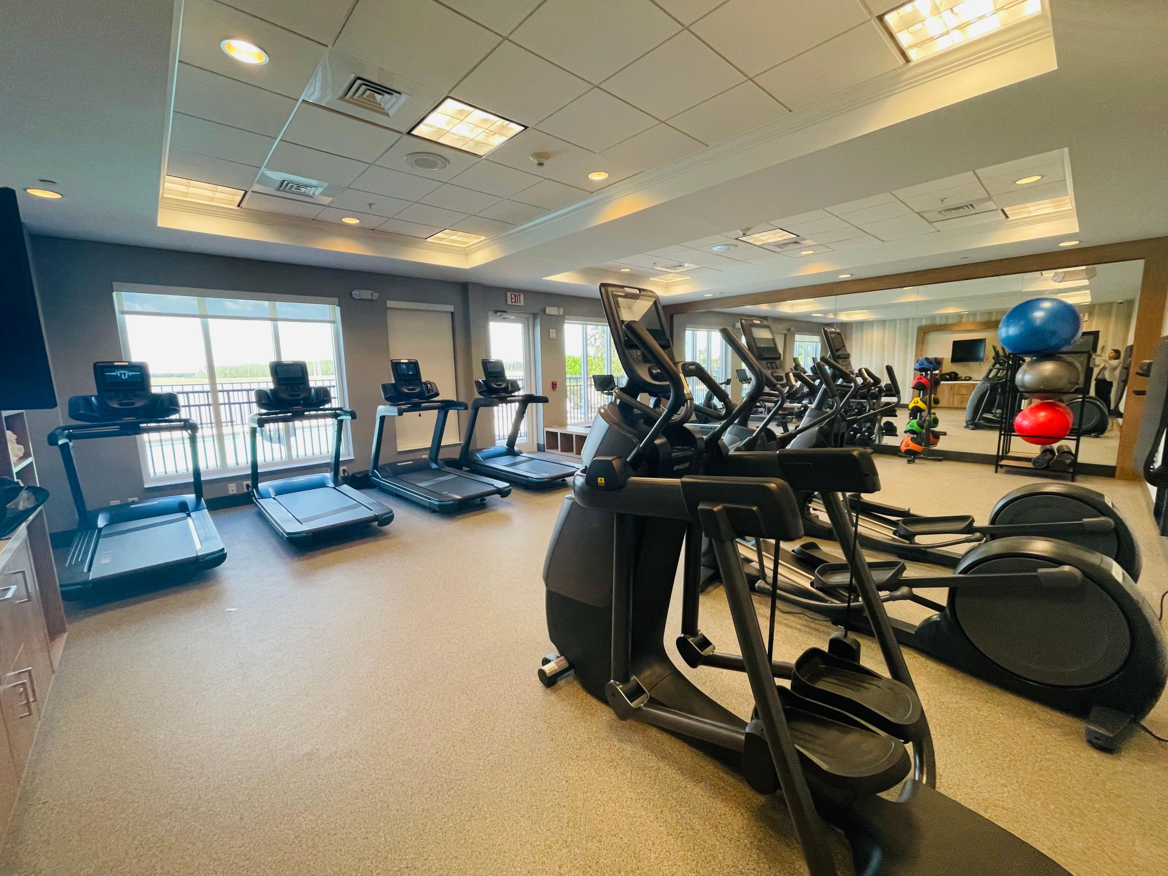 Maintain your workout routine in our state-of-the-art fitness center, featuring PRECOR equipment, Peloton bike, chilled towels, and a lake view to enhance your exercise experience.  