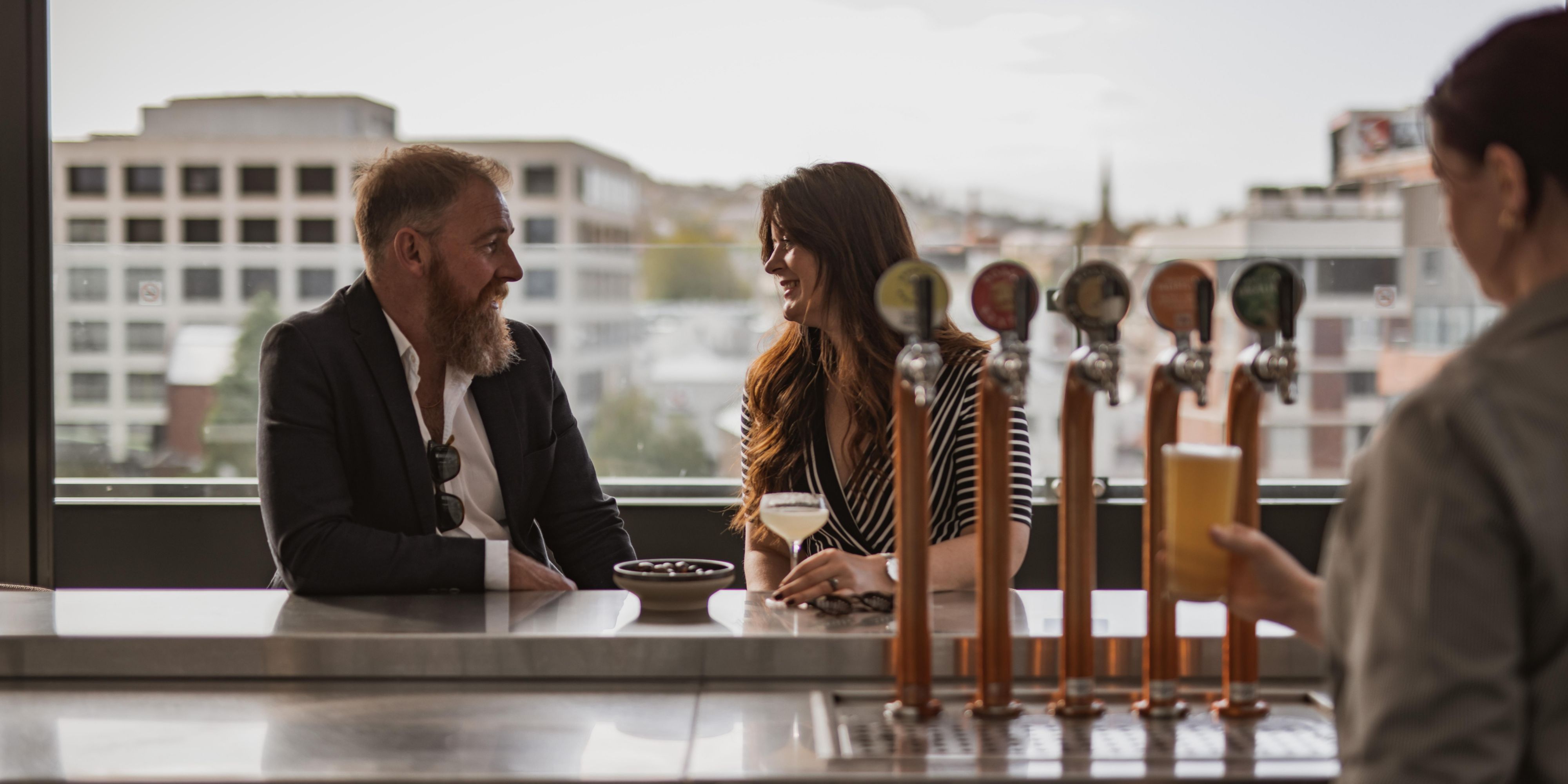 couple enjoying drinks at The Deck