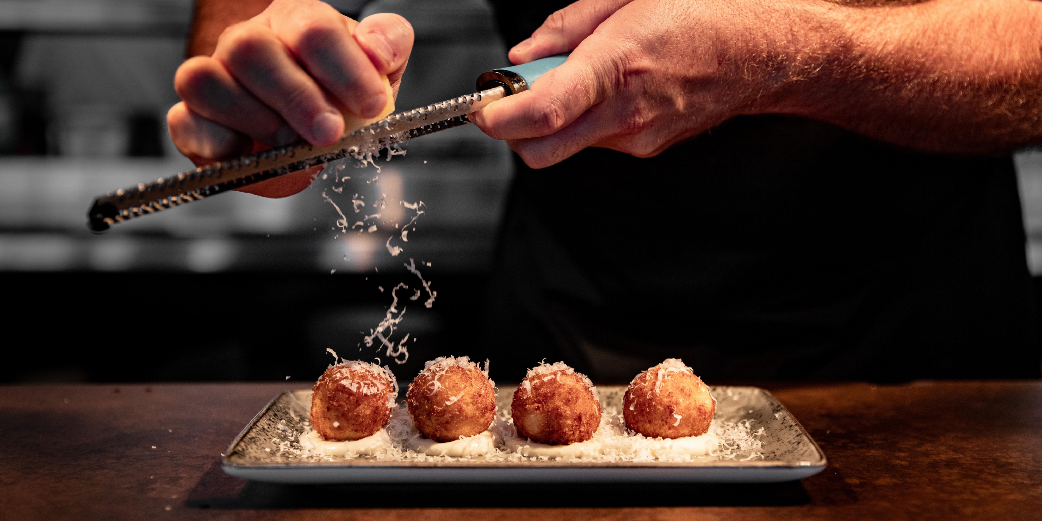 chef garnishing food at The Deck