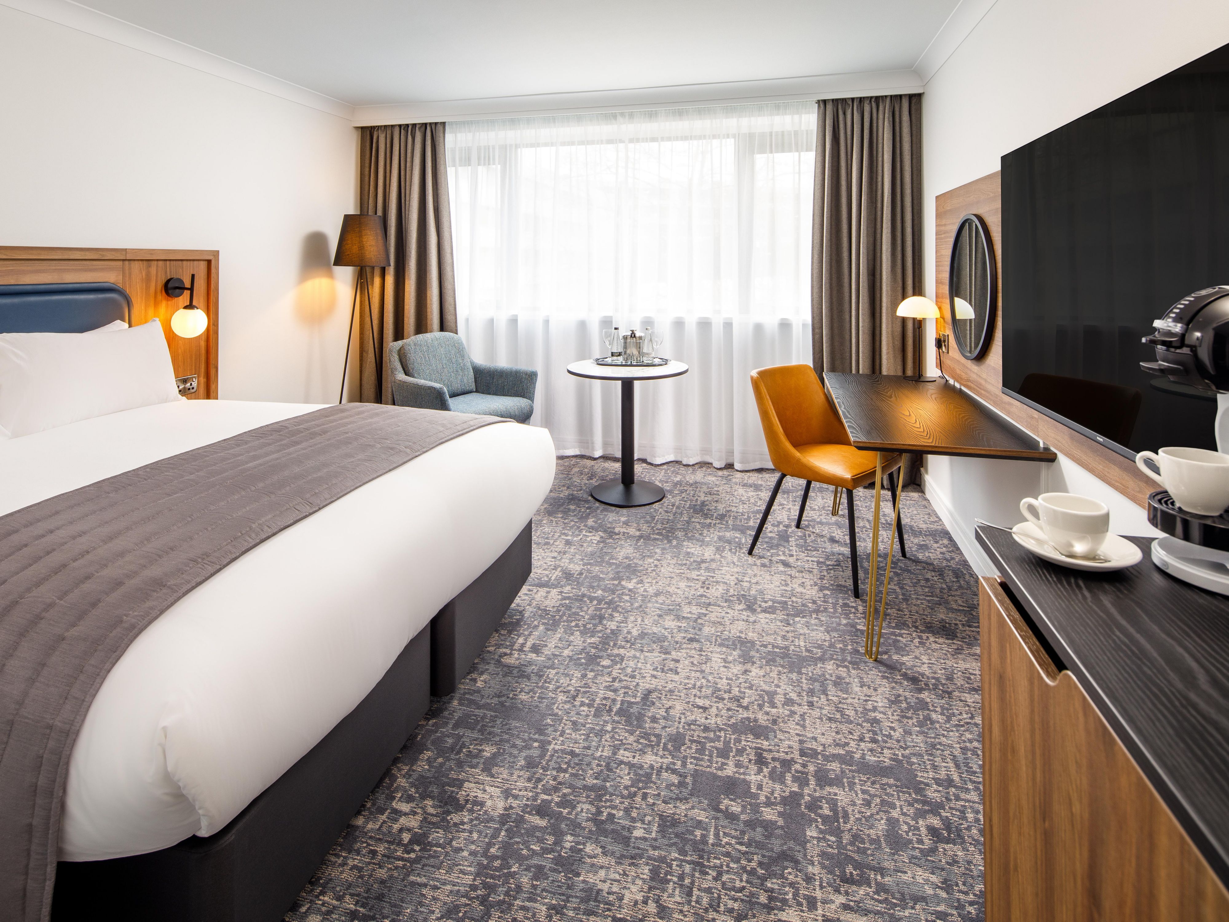 Spacious premium room with kind bed and coffee machine.