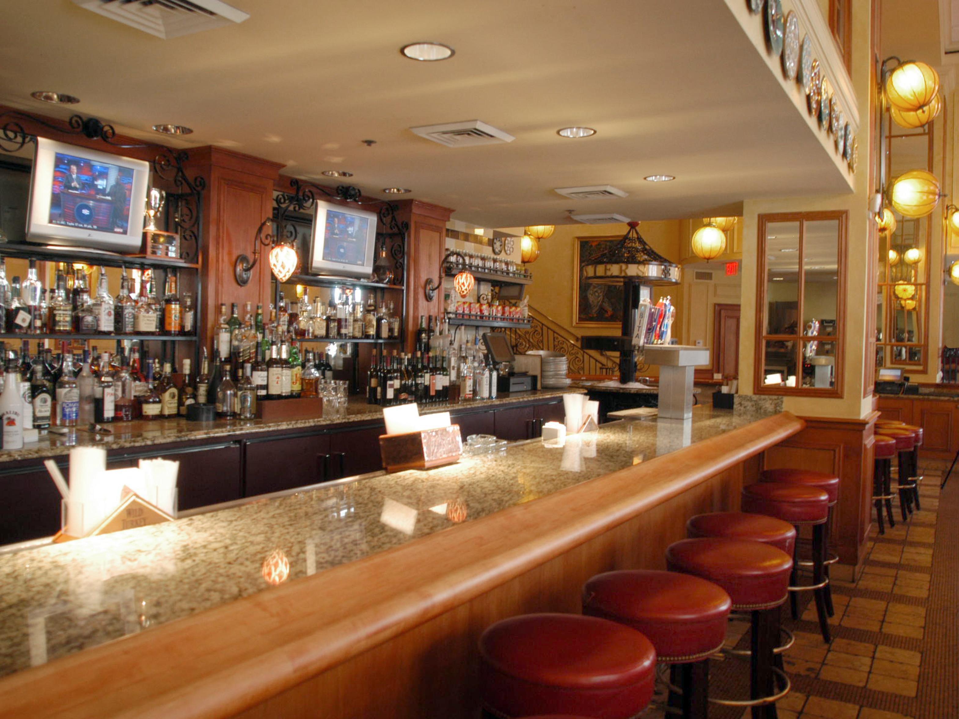 Explore an extensive selection of over 150 bourbons and American whiskeys at Bourbon House, perfect for connoisseurs and newcomers alike.  