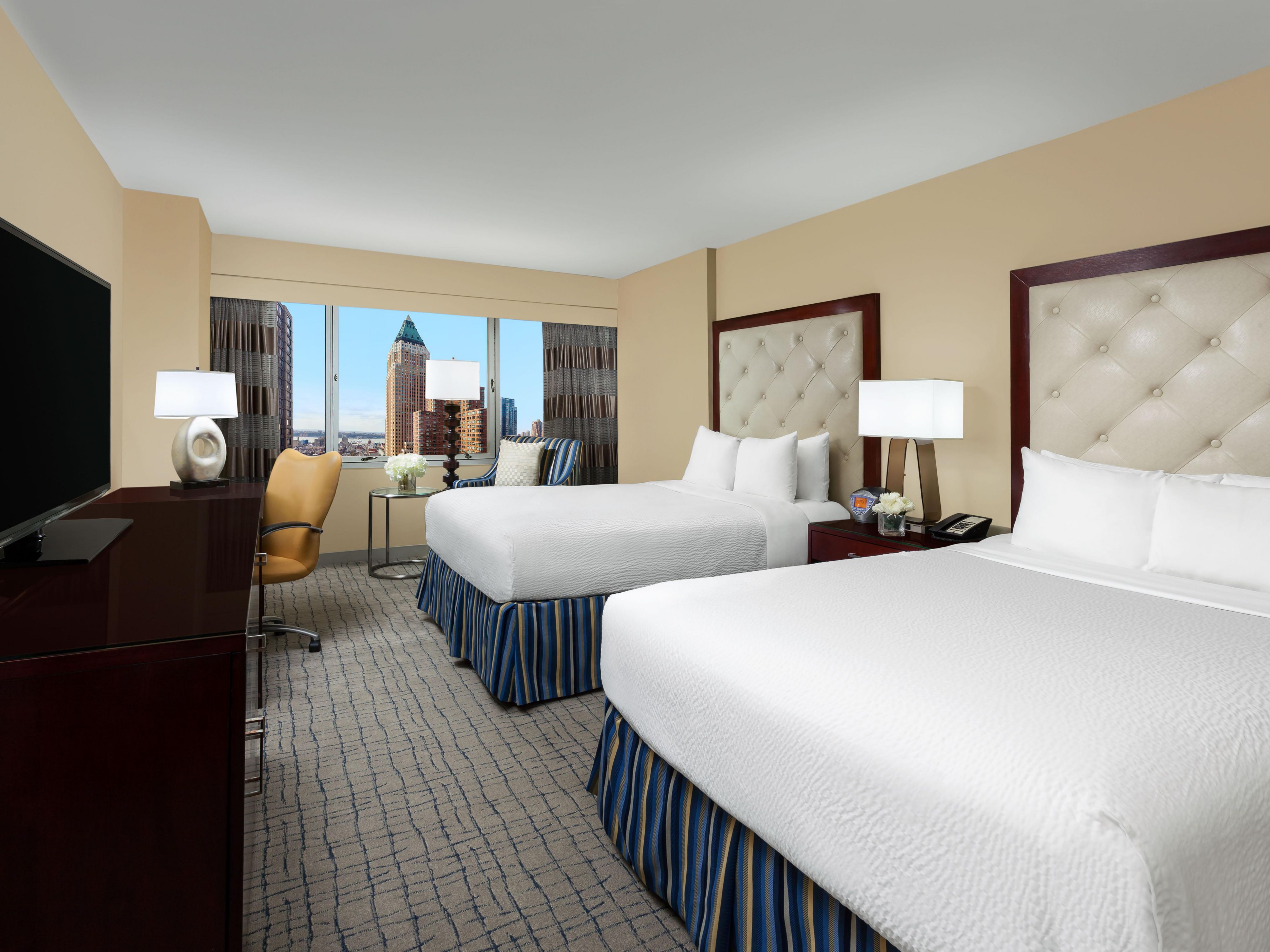 Relax in some of the largest guest rooms in NYC, designed with modern accents and plush bedding. Our rooms feature holistic Sleep Advantage amenities, including an aromatherapy kit, flat-screen HDTV, free Wi-Fi, and a work desk to stay productive. Unwind while you soak in stunning Midtown views.