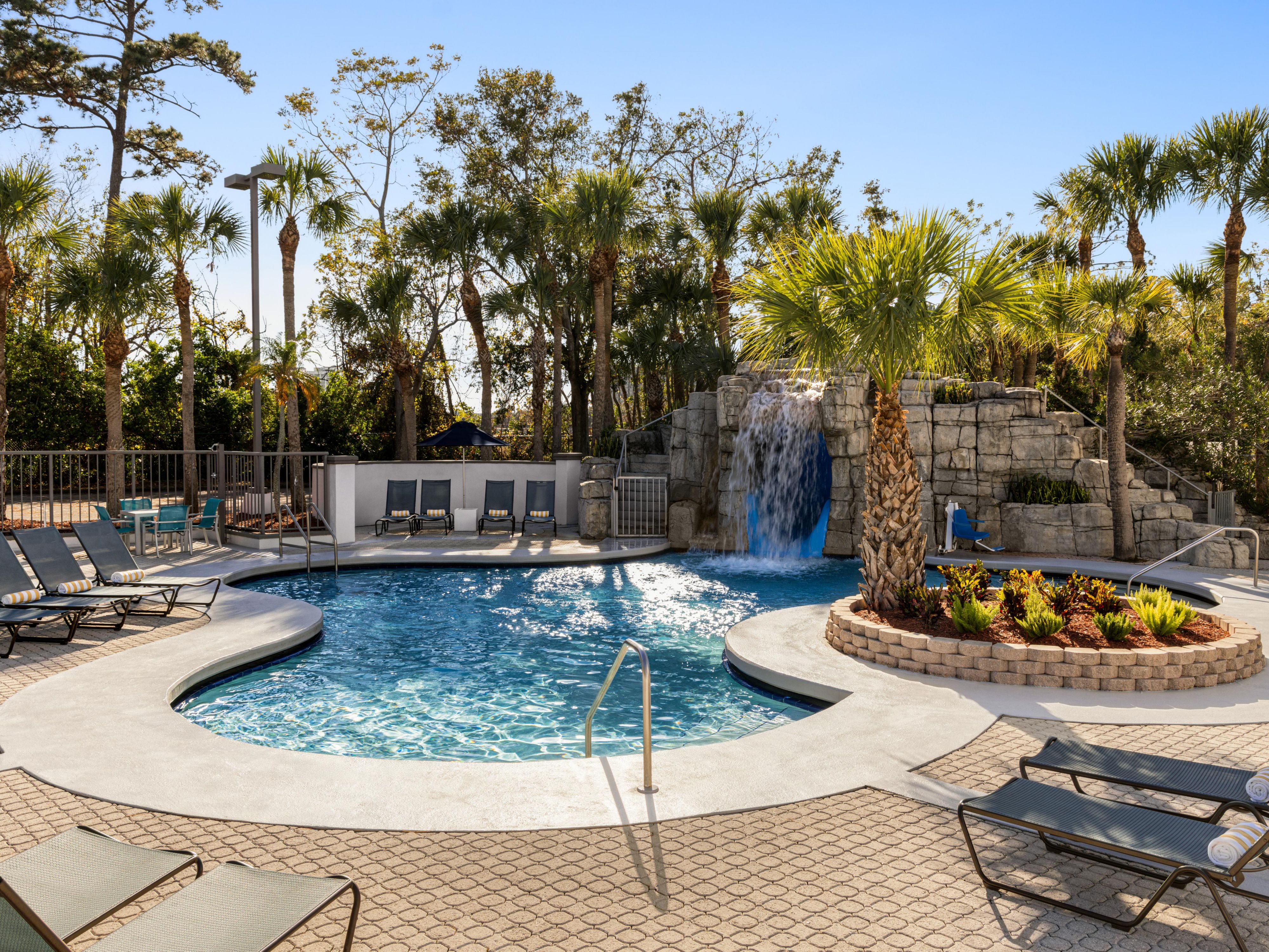 Relax by our inviting resort style outdoor pool surrounded by lush palms and a cascading waterfall. Kids will love the 50-foot waterslide, while adults can soak up the Florida sunshine or lounge on the patio. It's the perfect spot for fun and relaxation in Orlando! Pool open 9:00 AM – 11:00 PM.