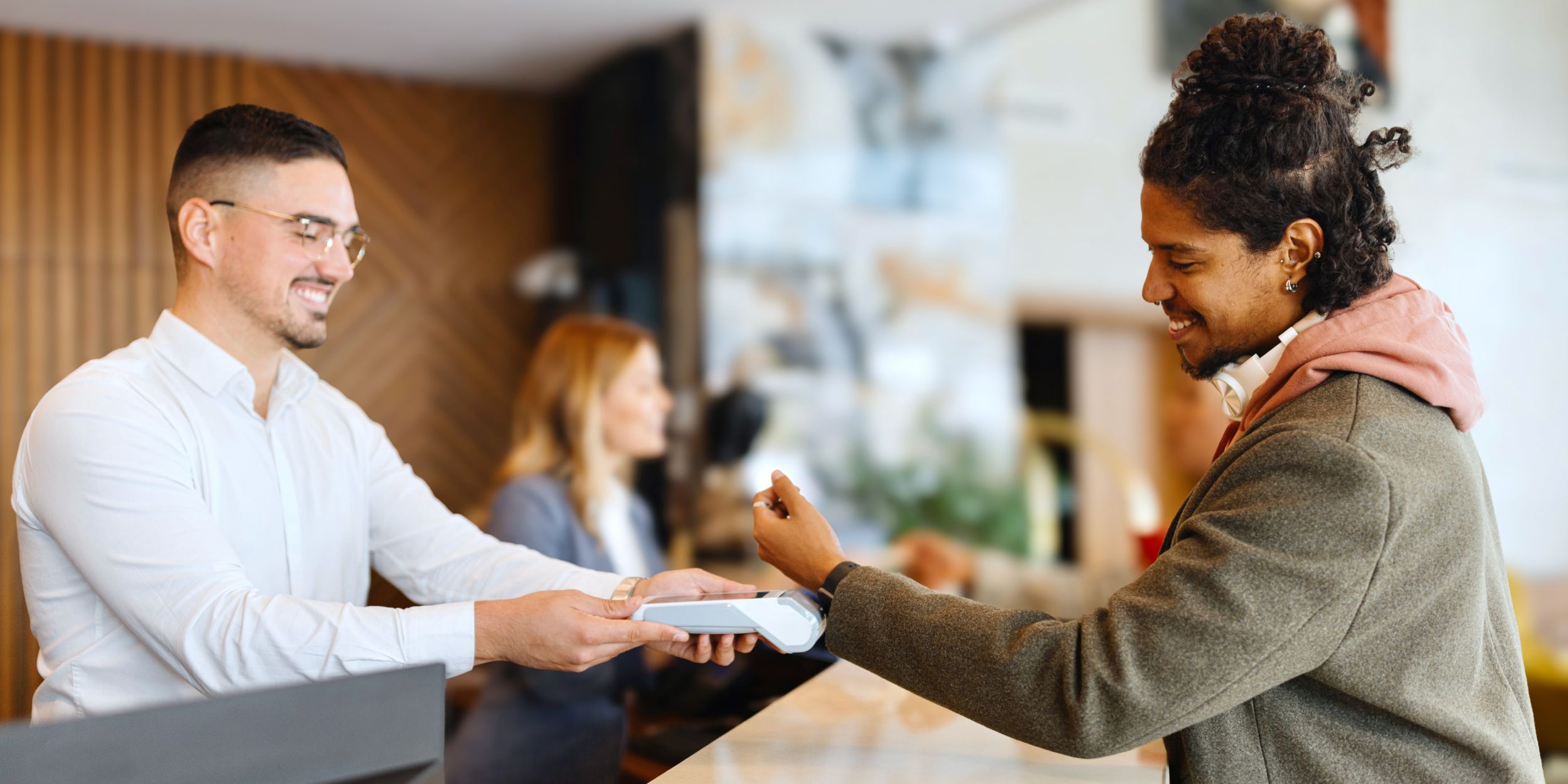 Man checking in at reception desk
