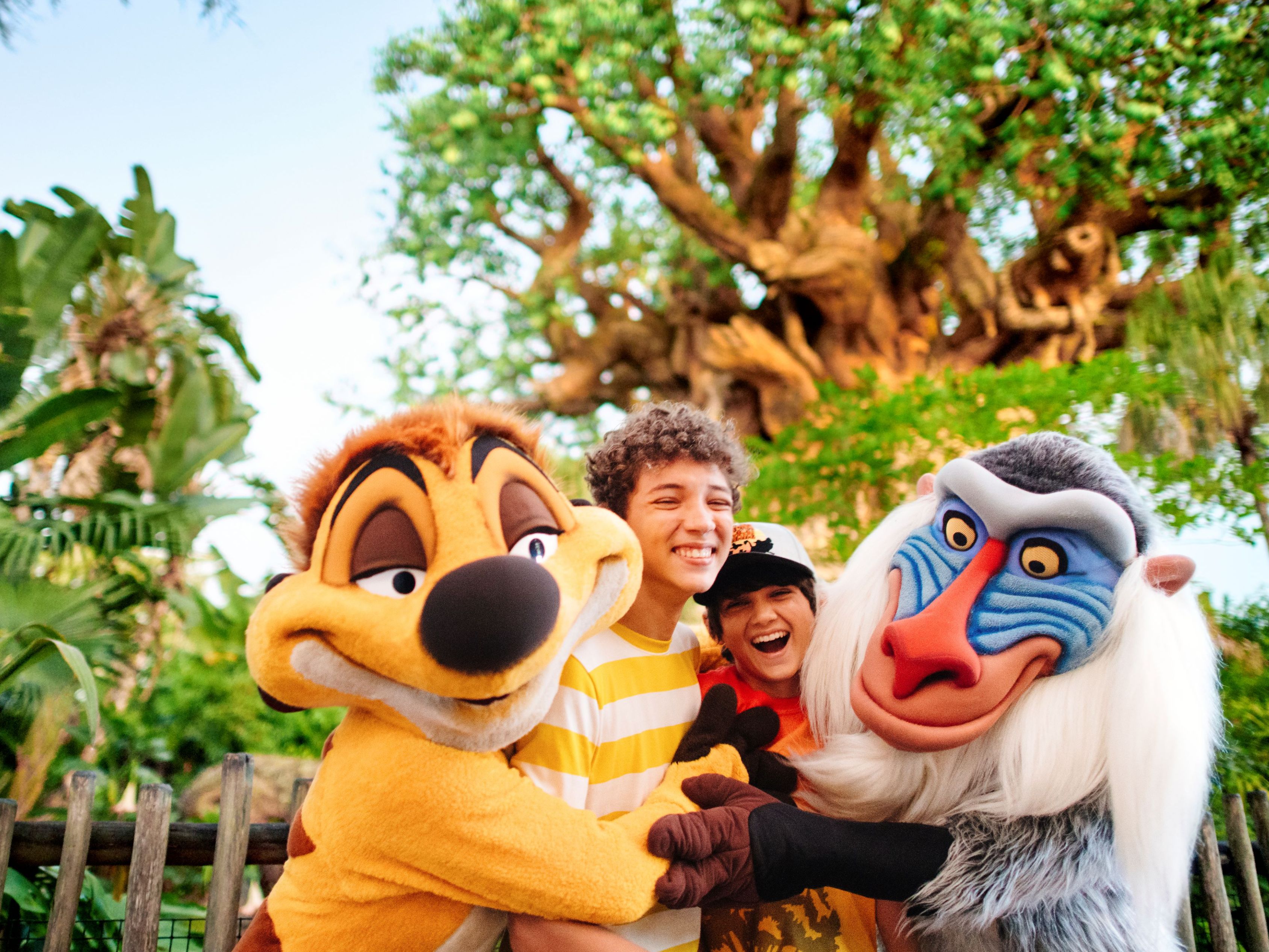 Characters from Lion King giving hugs to kids