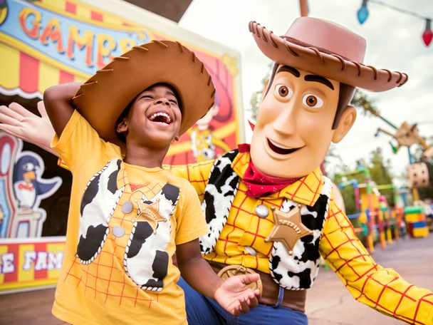 Character Woody laughing with young boy