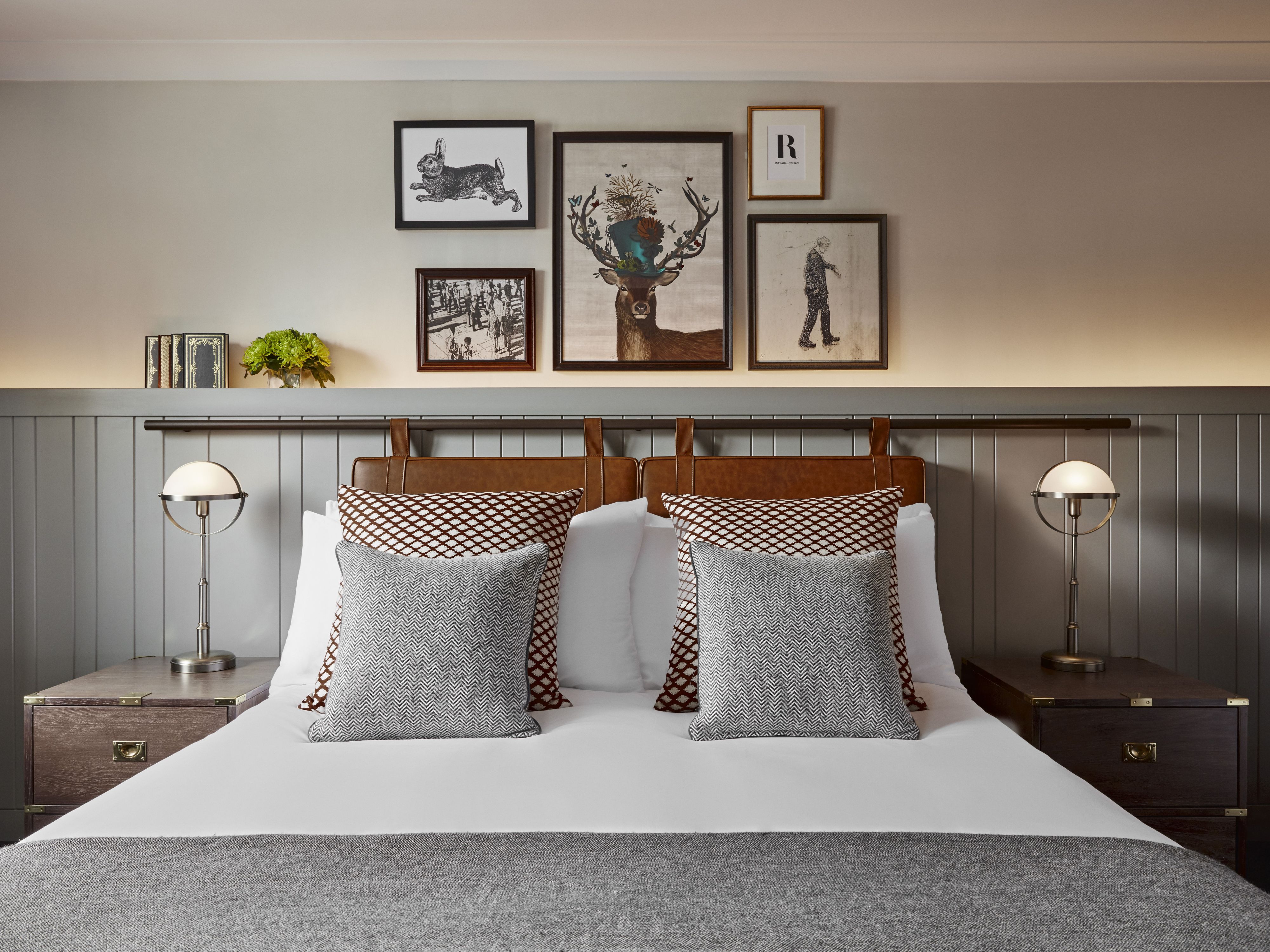 Hotel bed with pictures on the wall