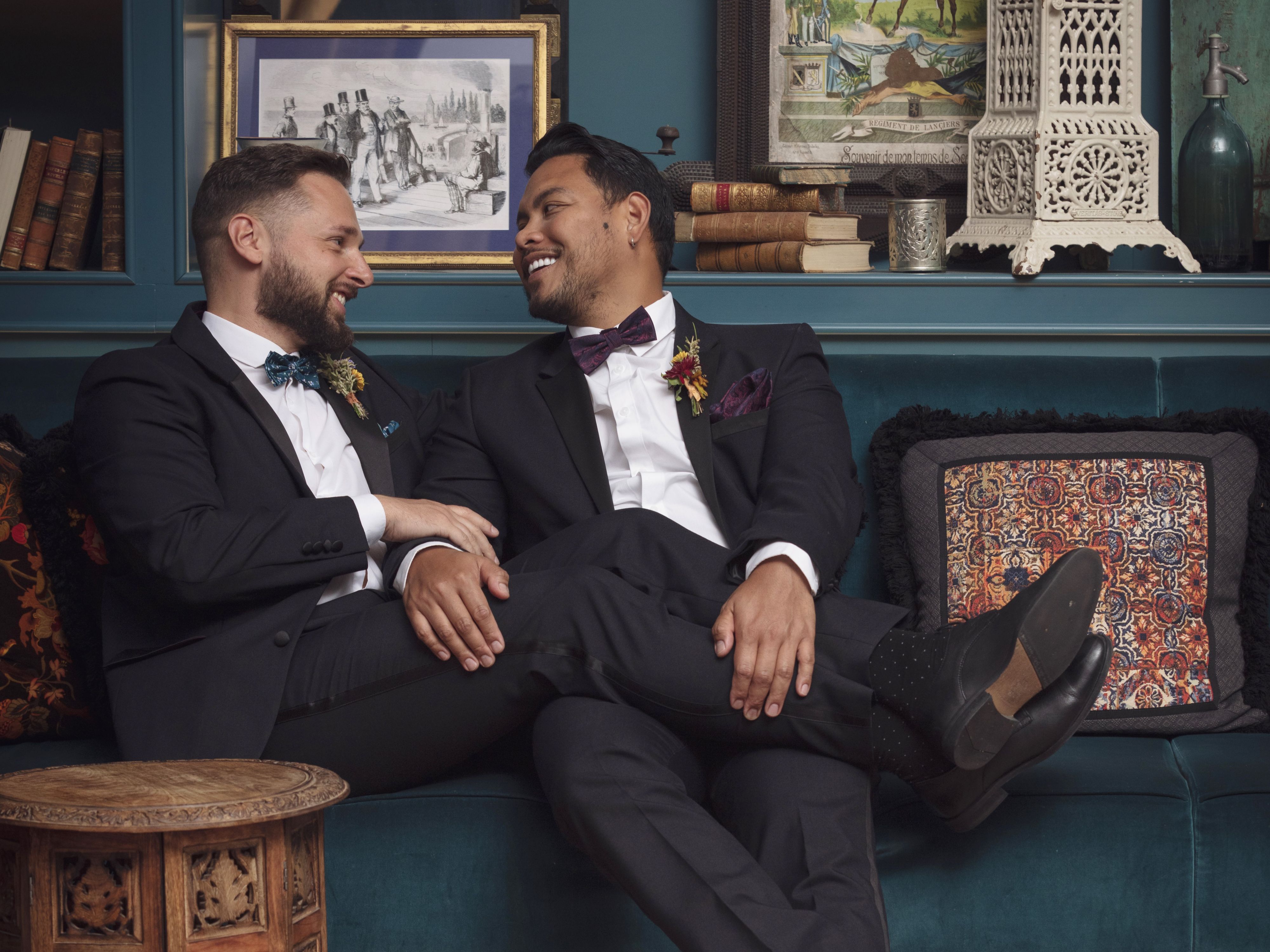 Grooms embracing on their wedding day