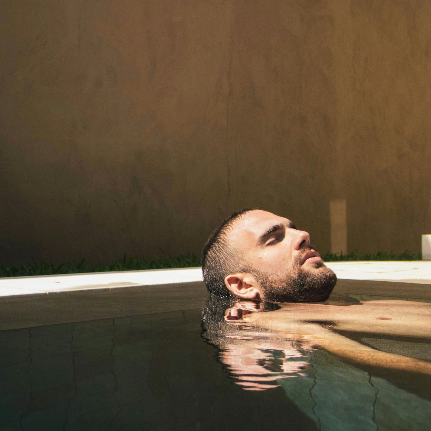 Man floating in spa pool
