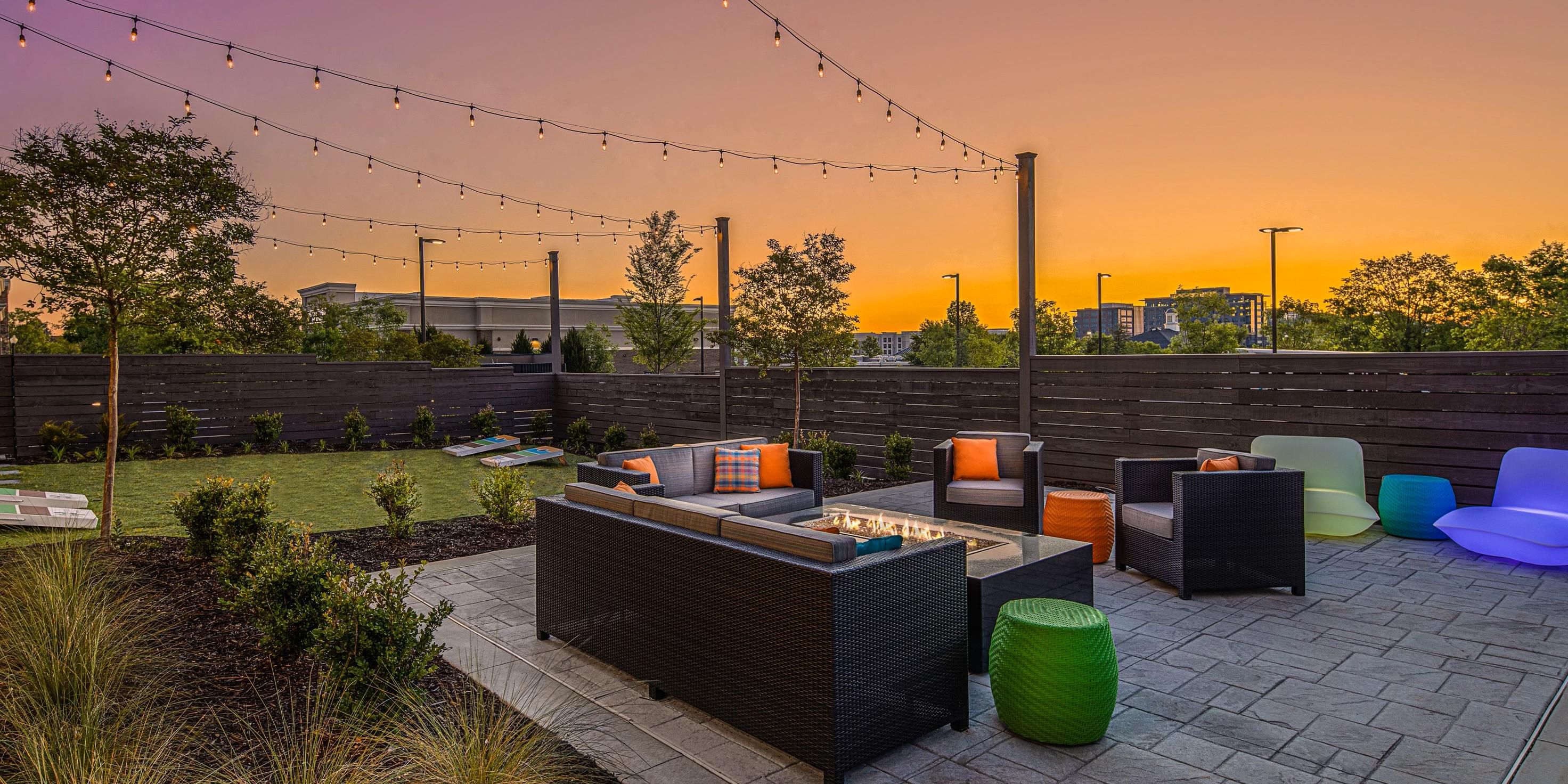 outdoor patio during sunset with seating and games.