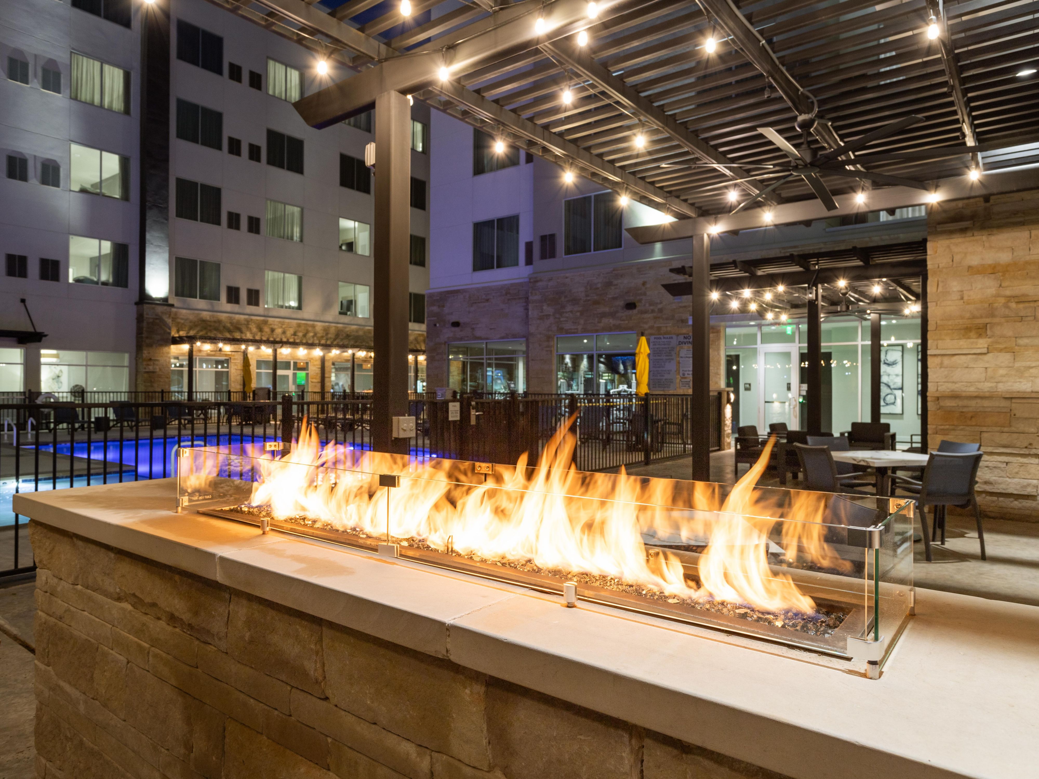 Step onto our inviting outdoor patio, where a fireplace casts a warm and welcoming glow. With comfortable lounges and tables shaded by umbrellas, it's the perfect setting to share drinks and special moments with friends, family, or colleagues. Feel the stress of the day melt away as you breathe in fresh air and savor the fireside ambiance. 