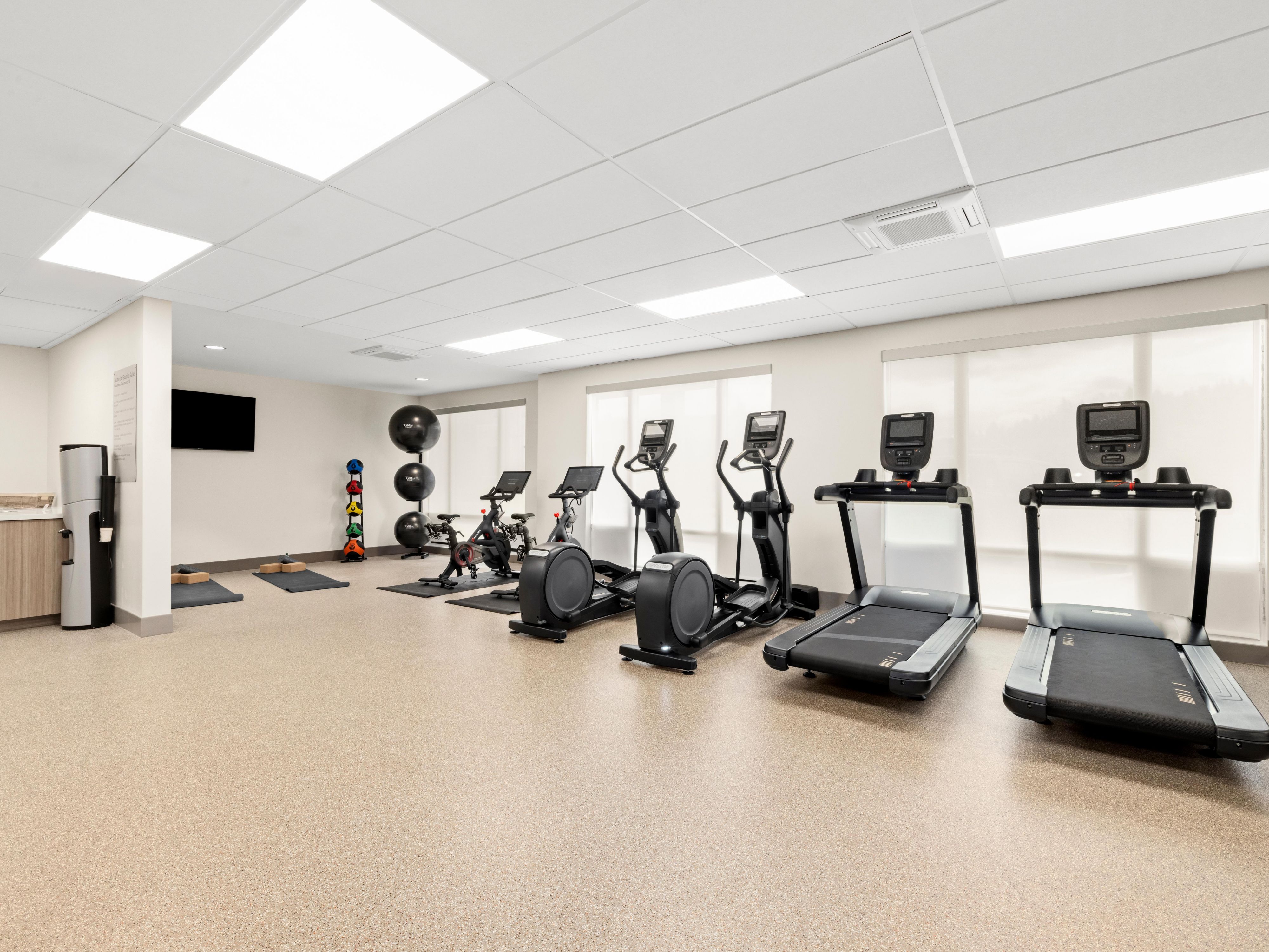 At EVEN Hotel Portland - Beaverton, we are proud to showcase our commitment to sustainability and wellness through our unique "Hero" floor, crafted in partnership with Nike. This innovative flooring solution utilizes recycled materials from Nike shoes, transforming them into durable, high-performance rubber products designed for high-traffic areas.