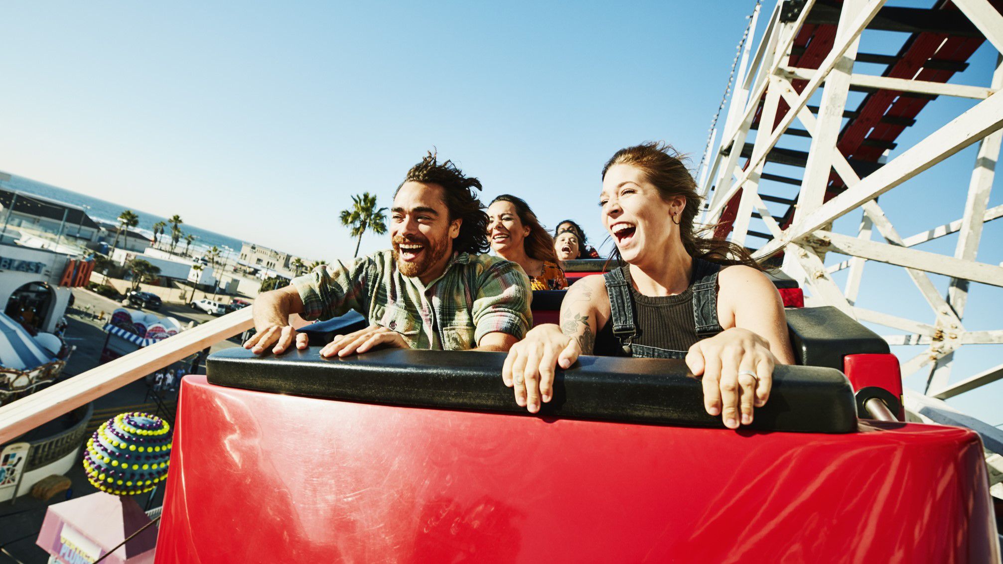 People riding a roller coaster at a theme park