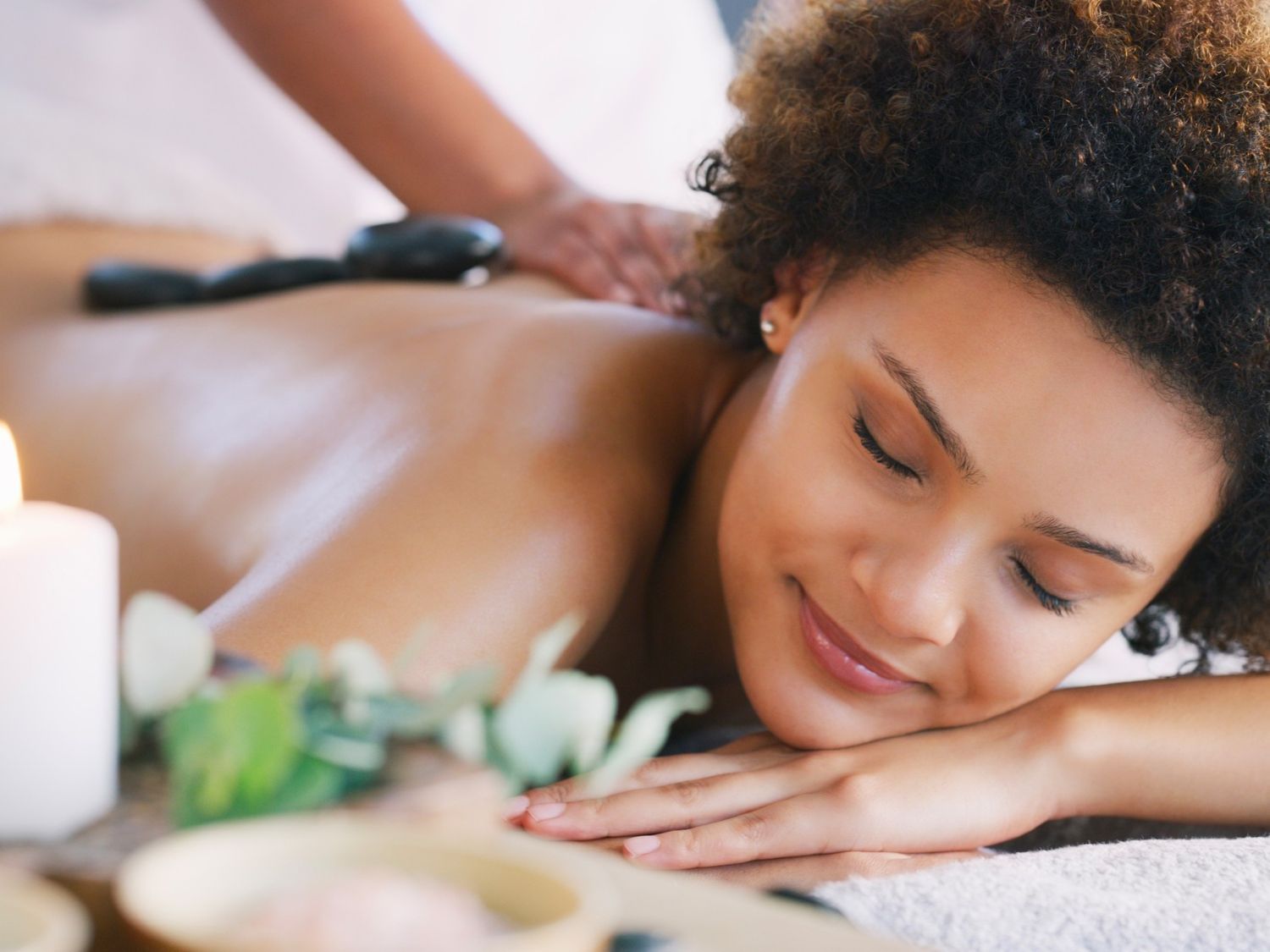 woman having a relaxing hot stone massage in a spa