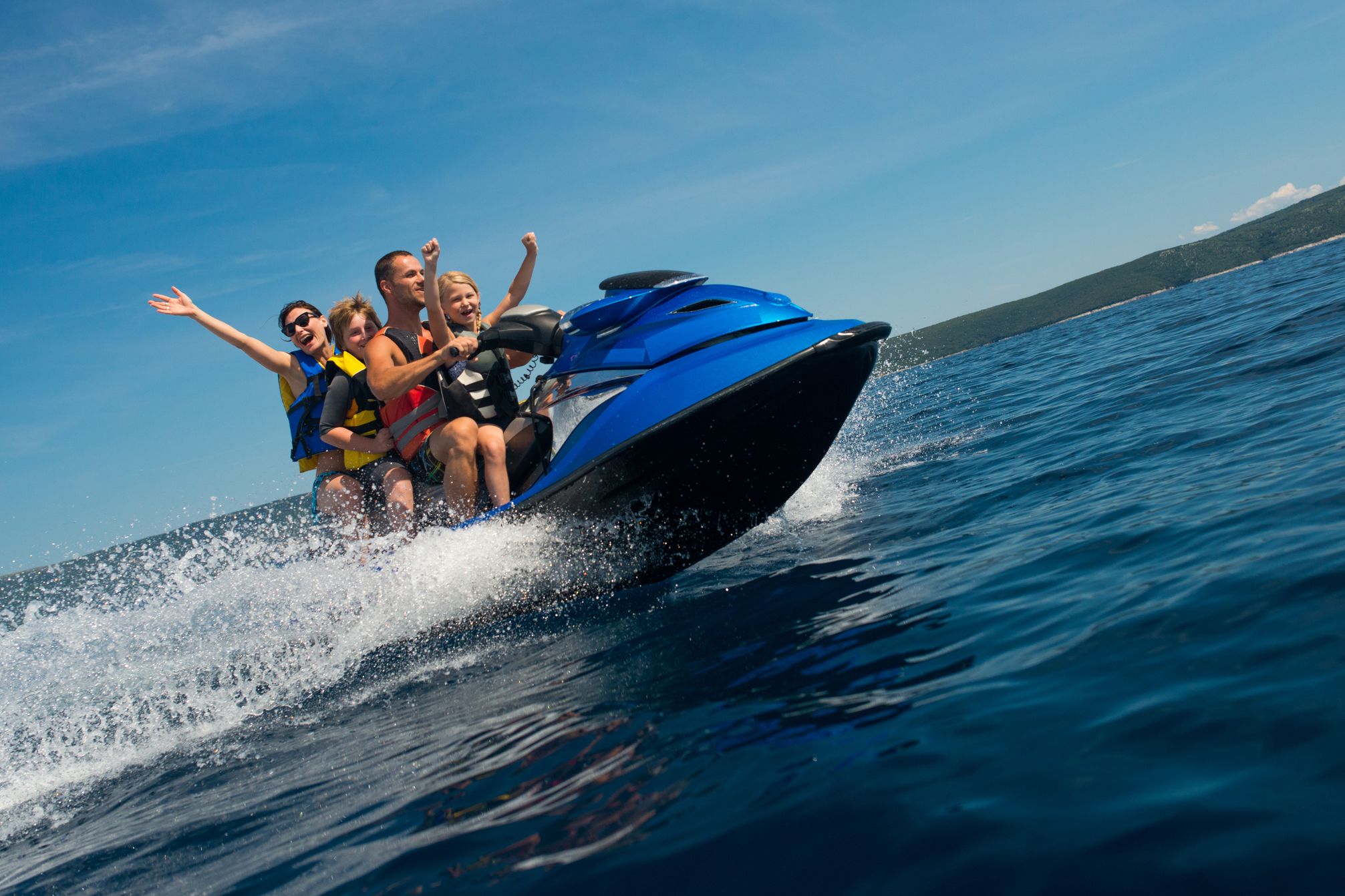 family riding a jet ski