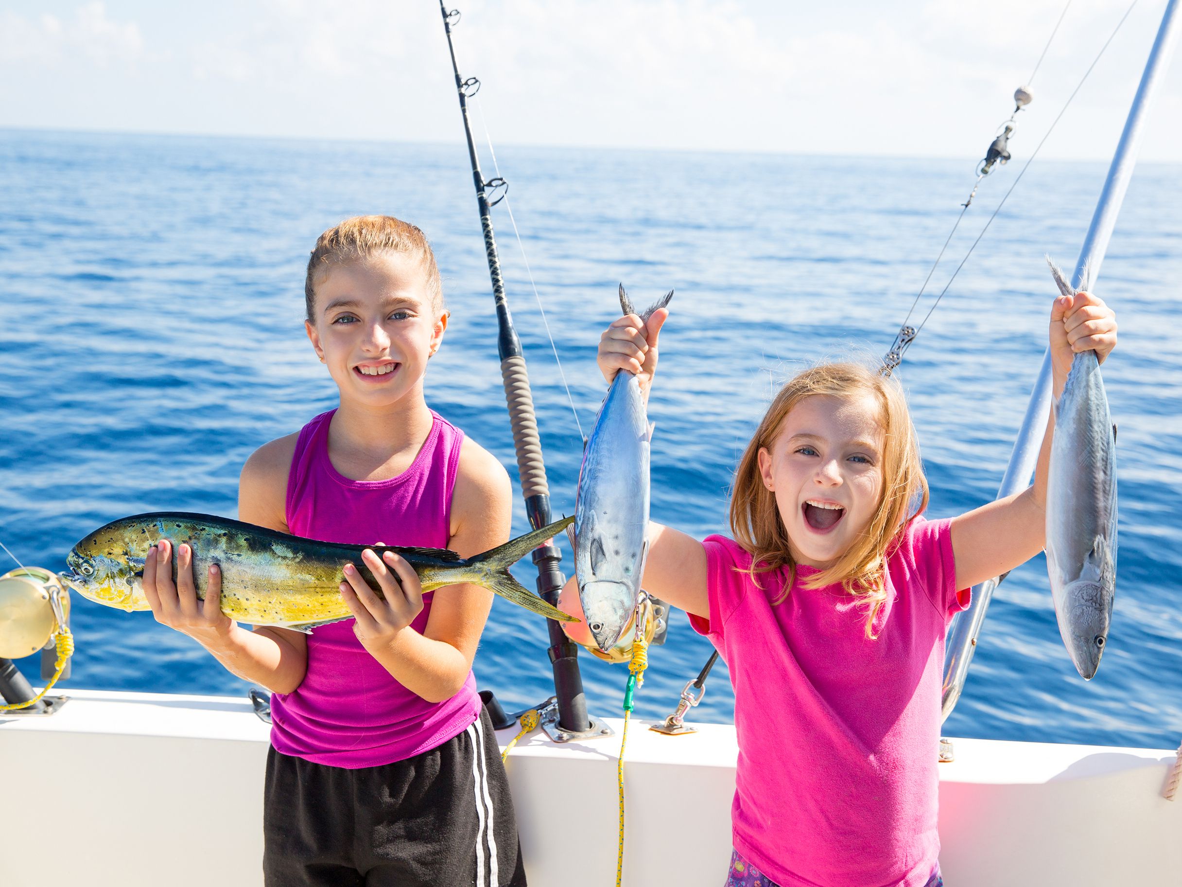 Girls holding up fish they caught