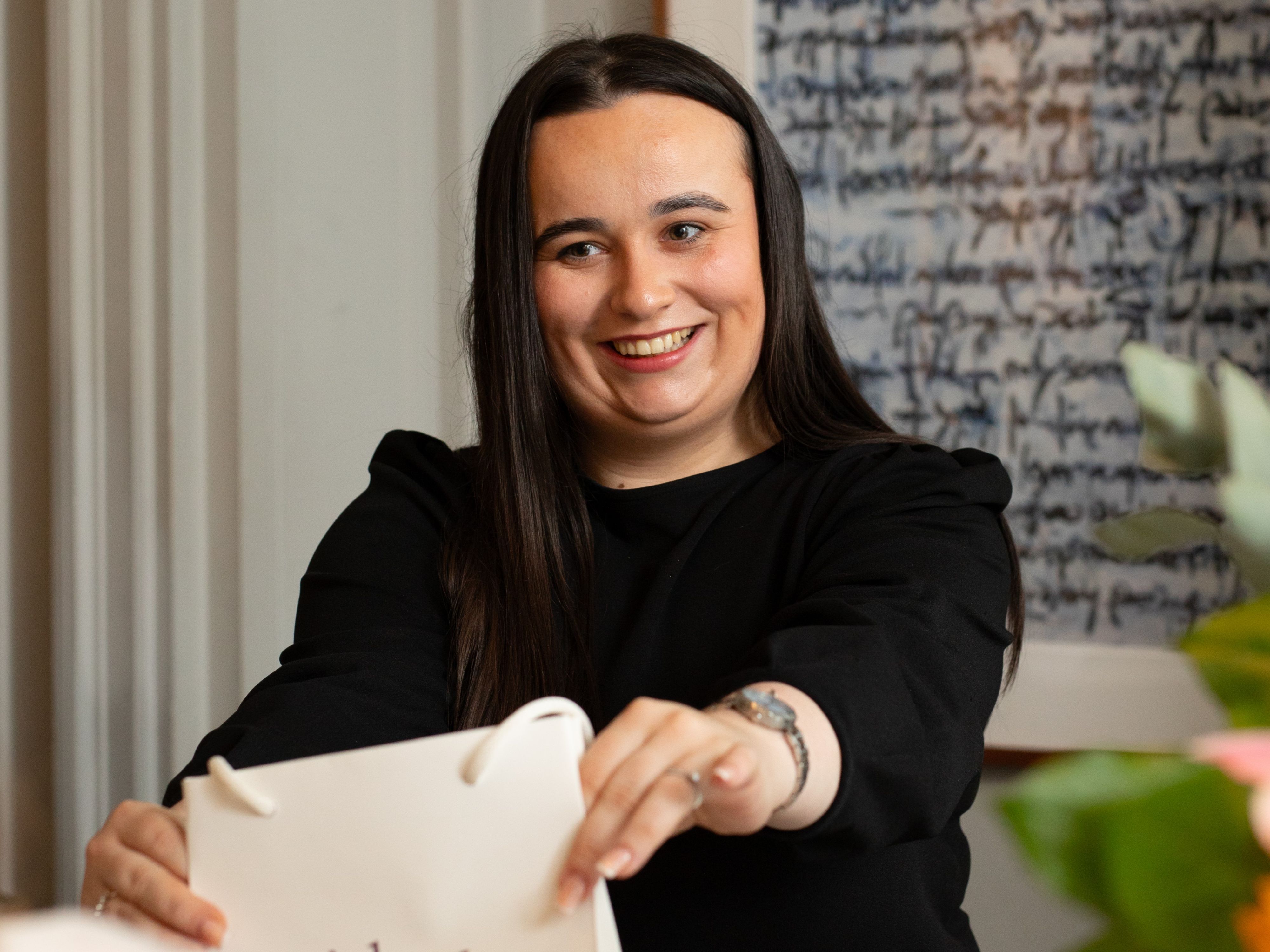 Woman handing over a gift bag