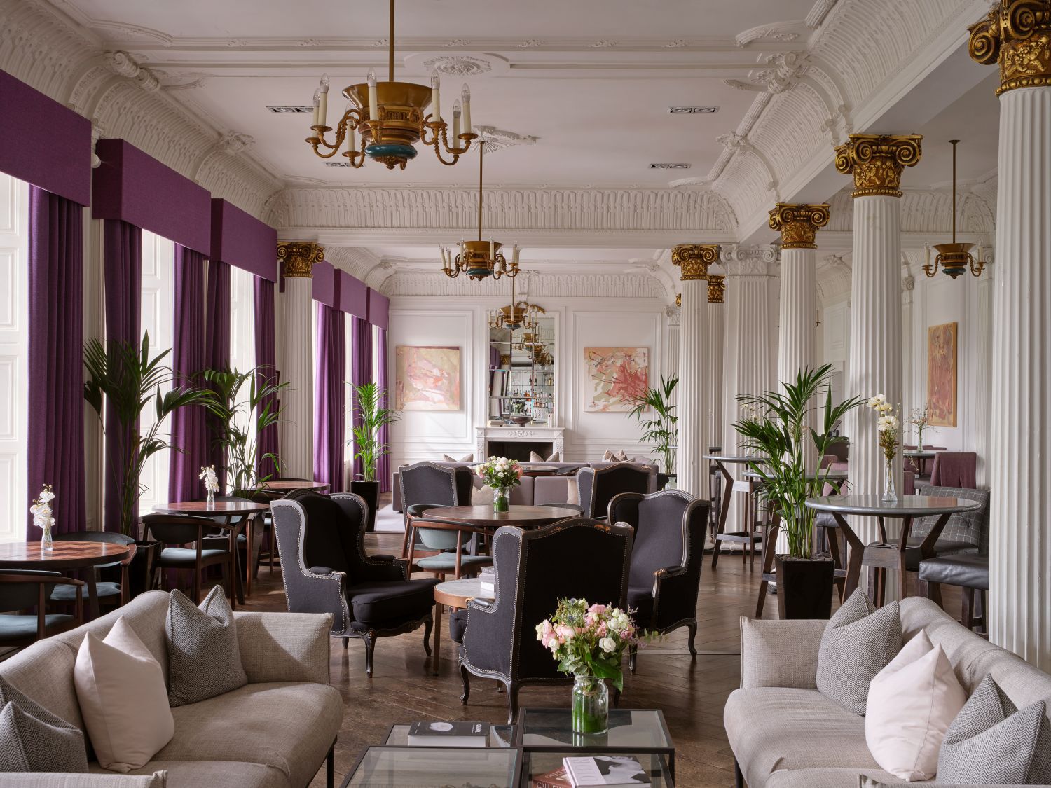 Large seating area with cosy sofas, armchairs and large windows
