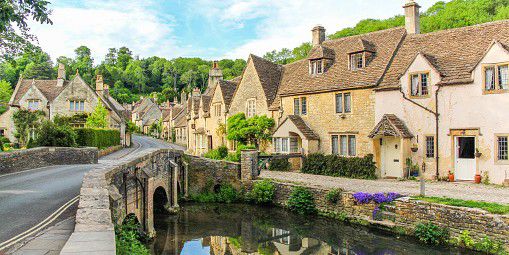 A picturesque view of cottages with Cotswold stone walls in Cotswolds, England