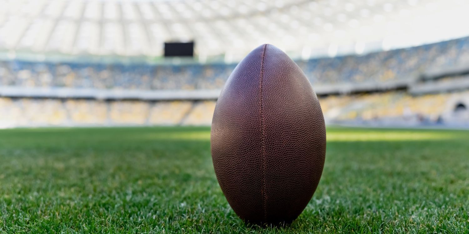 rugby ball on green grass at stadium