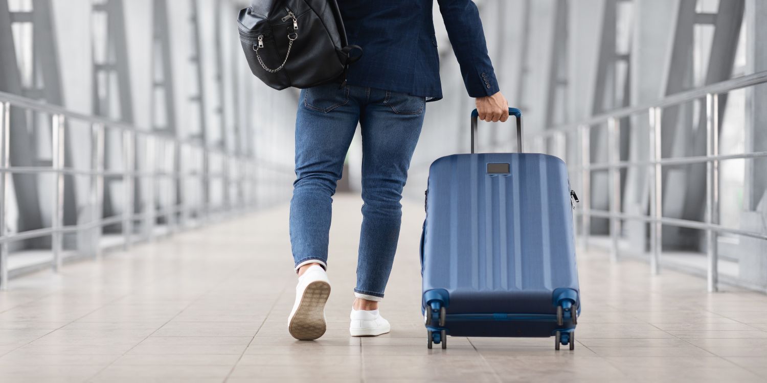 man with suitcase at a station