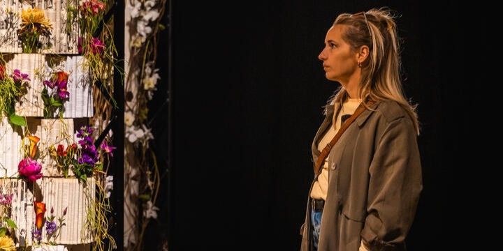 woman looking at a flower wall