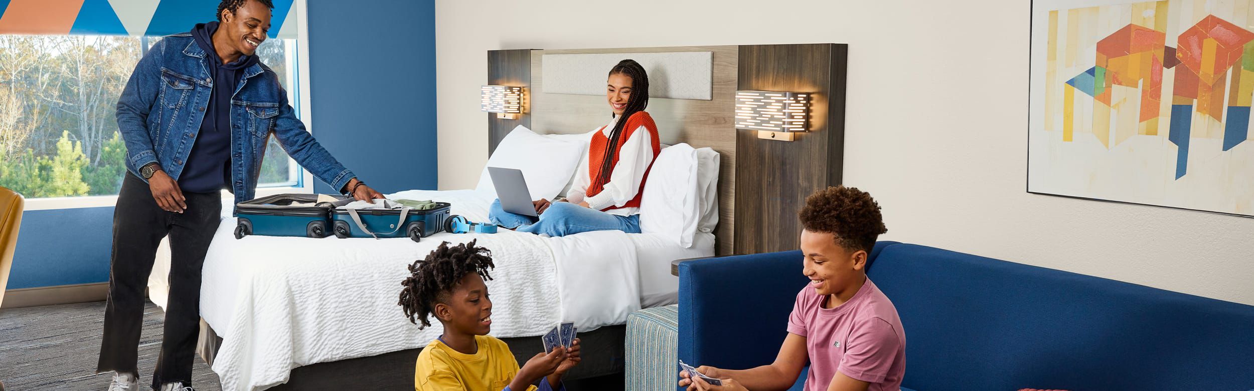 一家人正在酒店客房里整理行李