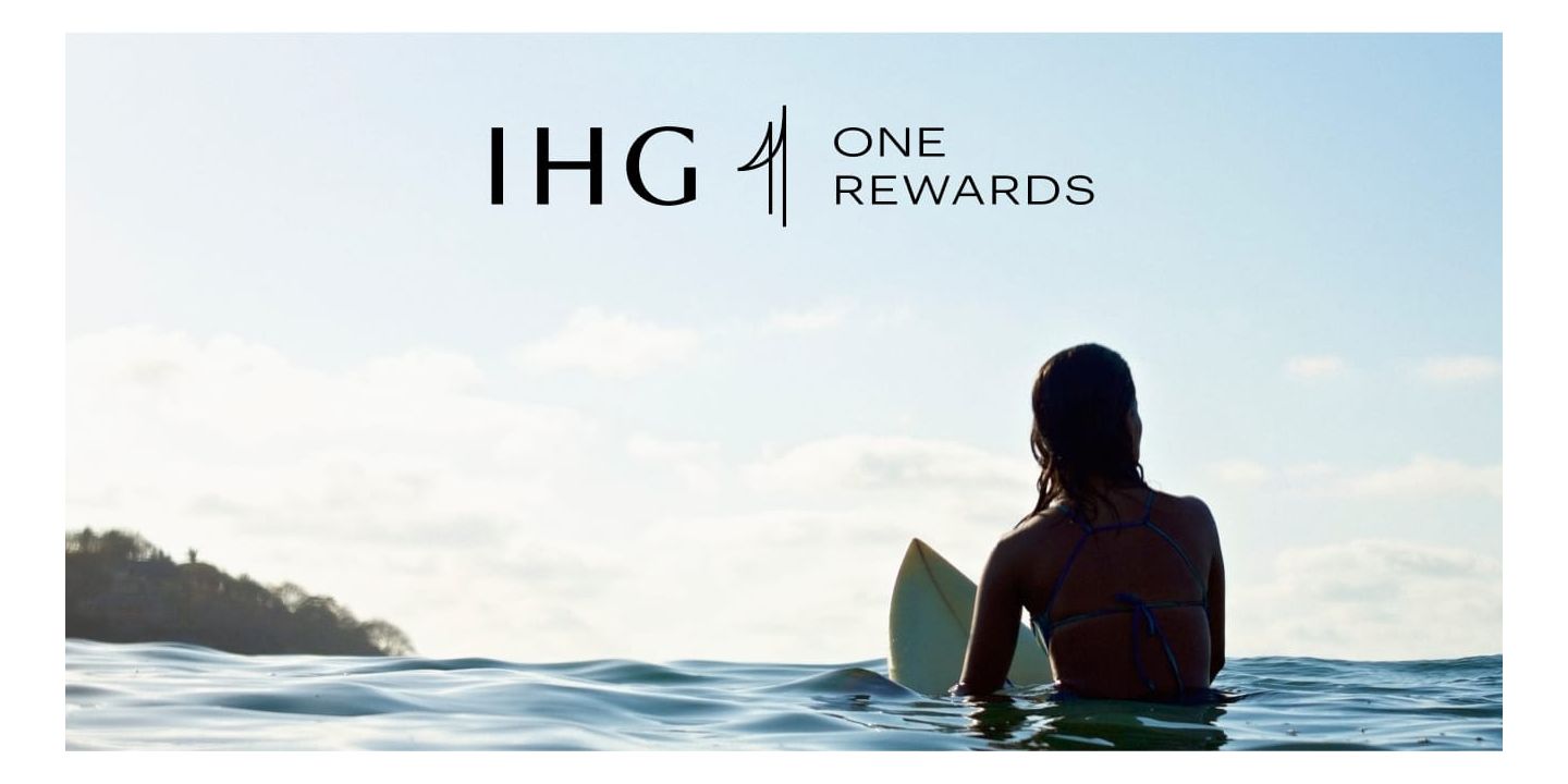 Water level view of a girl sitting on a surf board