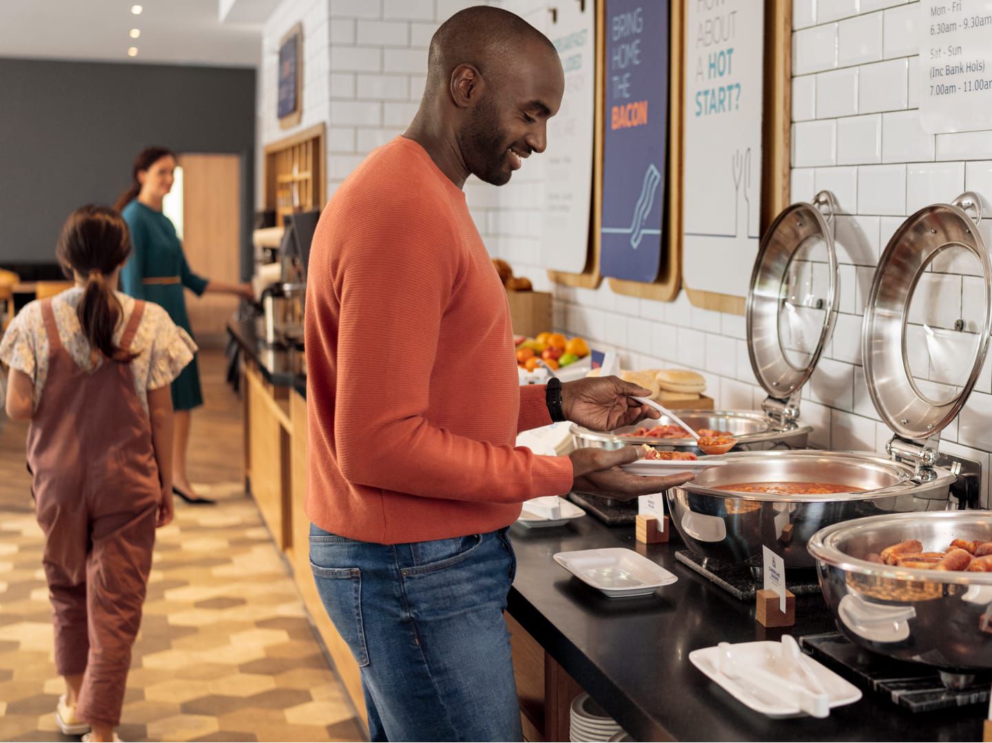 Man filling his plate at hot breakfast buffet